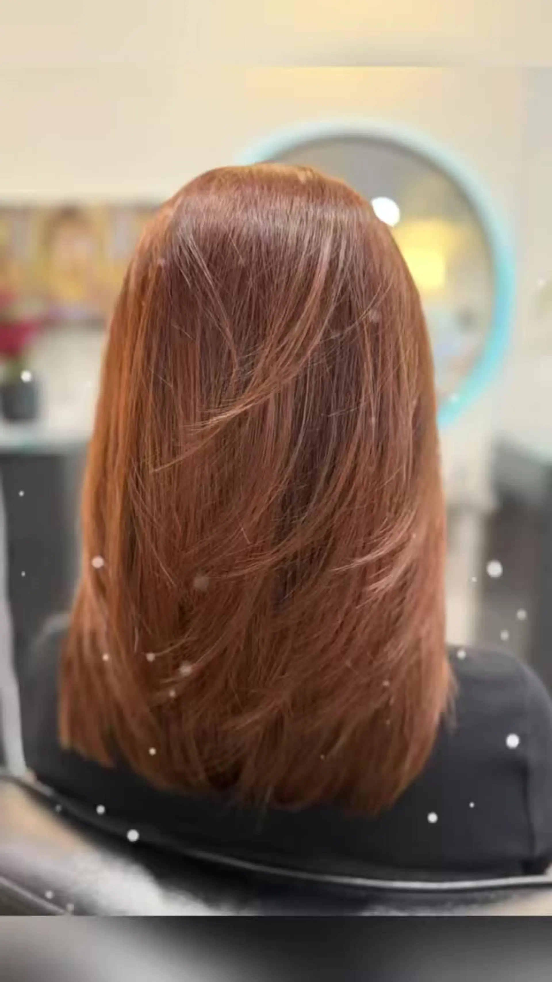 Medium-length glossy copper-auburn hair cut with soft, feathered layers and styled straight. 1