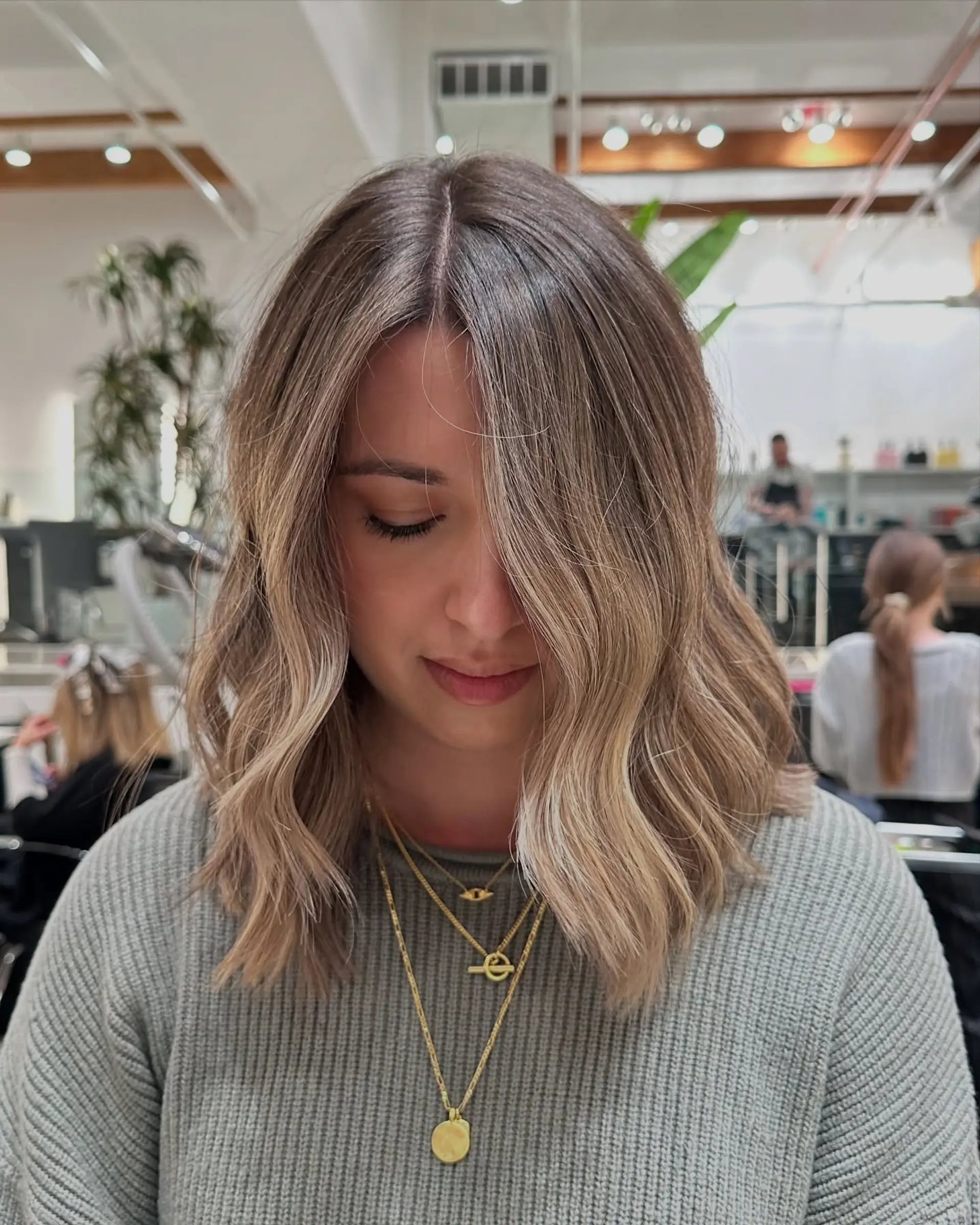 A long, layered cut with a bronde balayage, creating a soft, wavy and dimensional style. 2