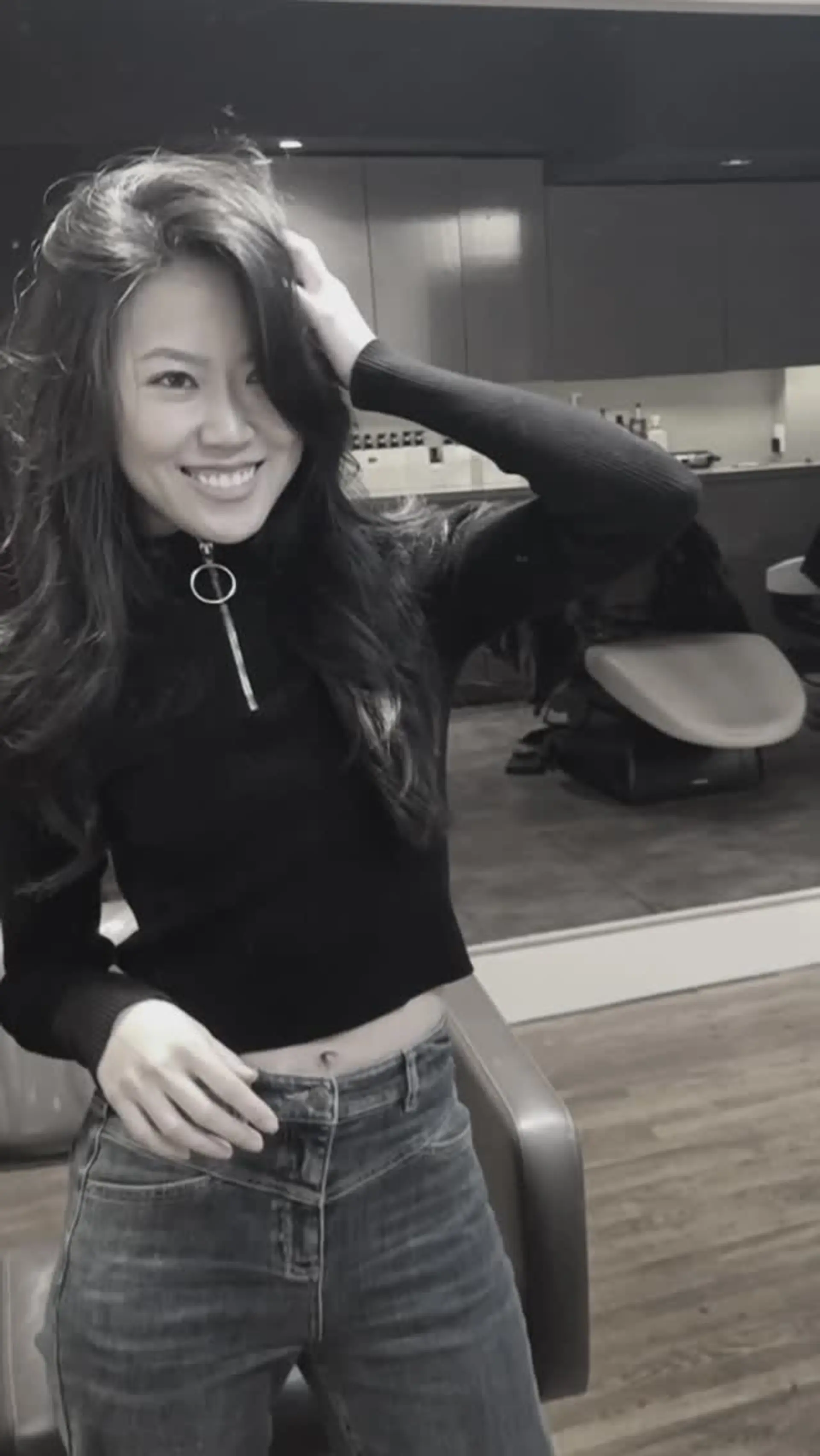 Long layered haircut styled with soft, voluminous waves and natural movement. 1