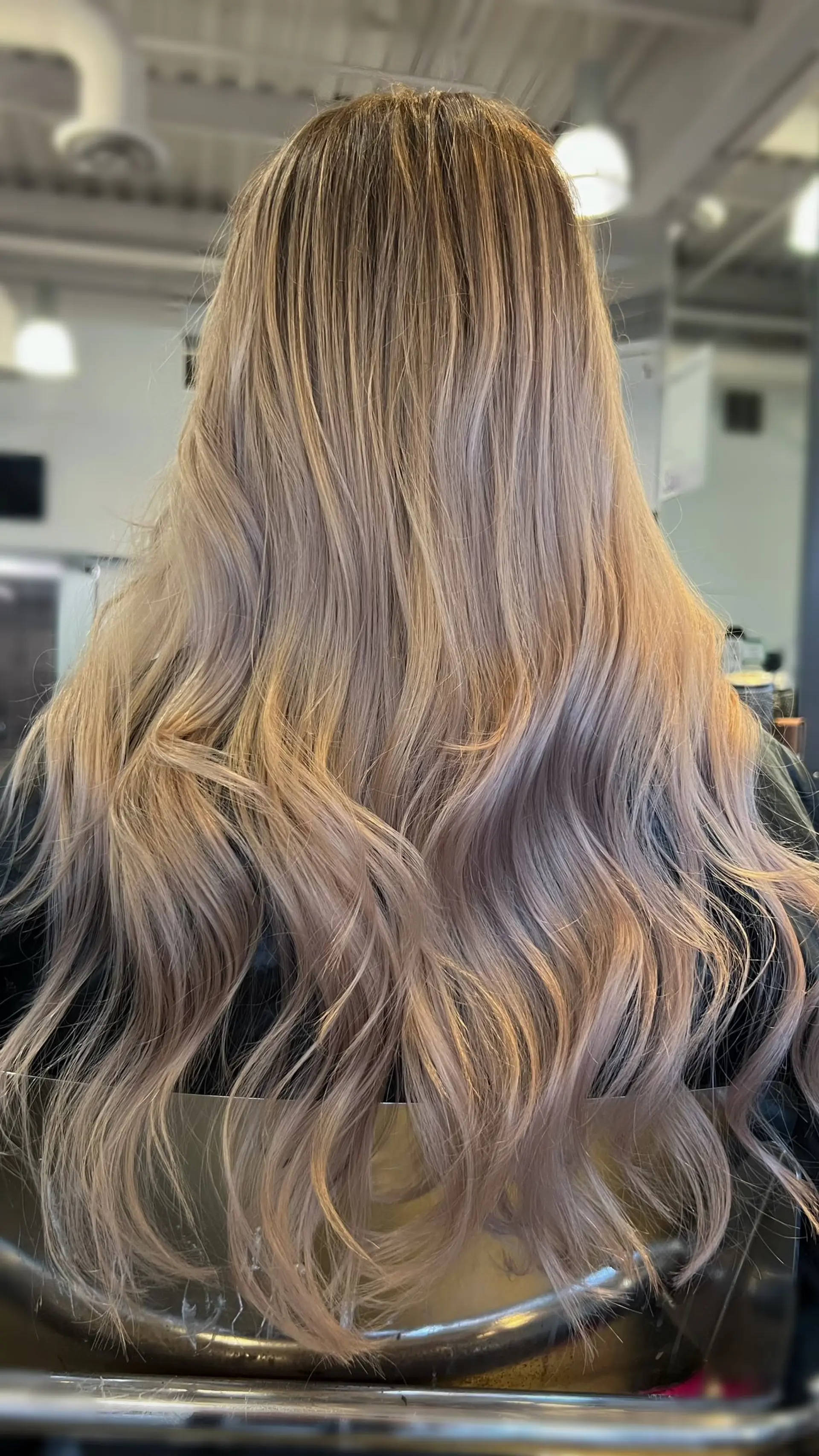 Long cool-toned ash blonde hair styled in soft, cascading waves. 1