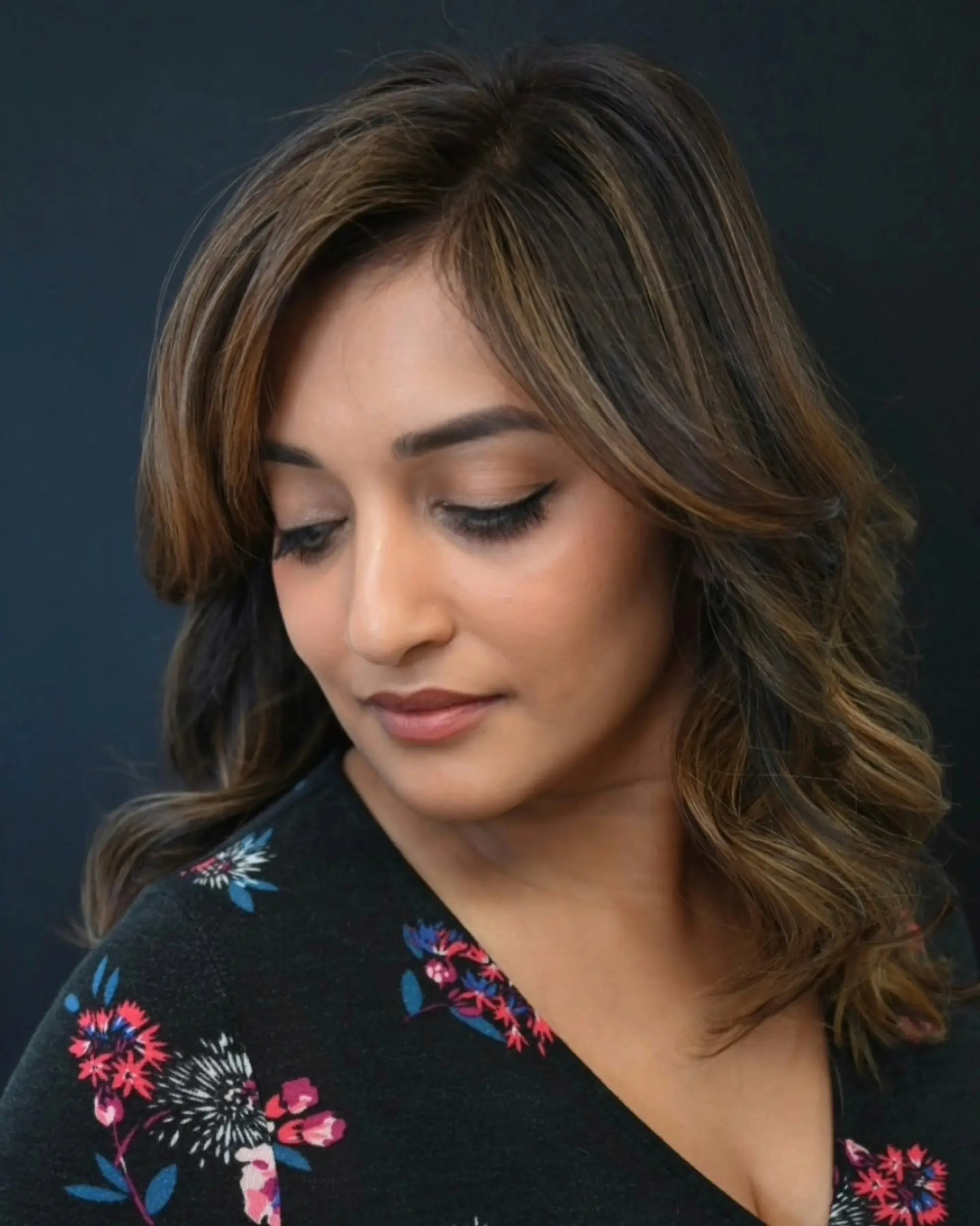 Medium-length dark brown hair featuring soft caramel dimensional highlights and voluminous loose waves. 1