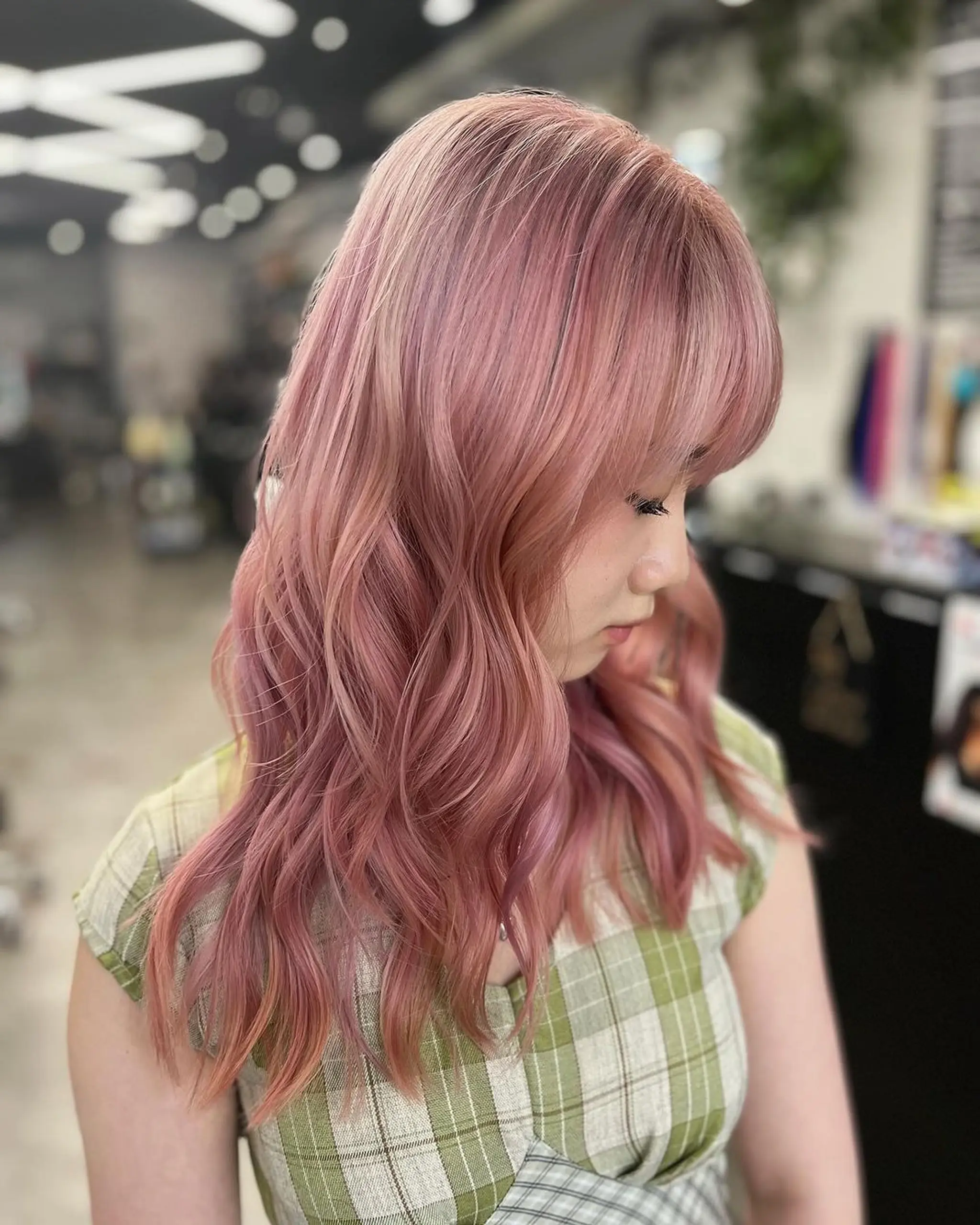 Medium-length, pastel pink wavy hair with blunt bangs and layered soft curls.
Stylist - @xcellent_jason
