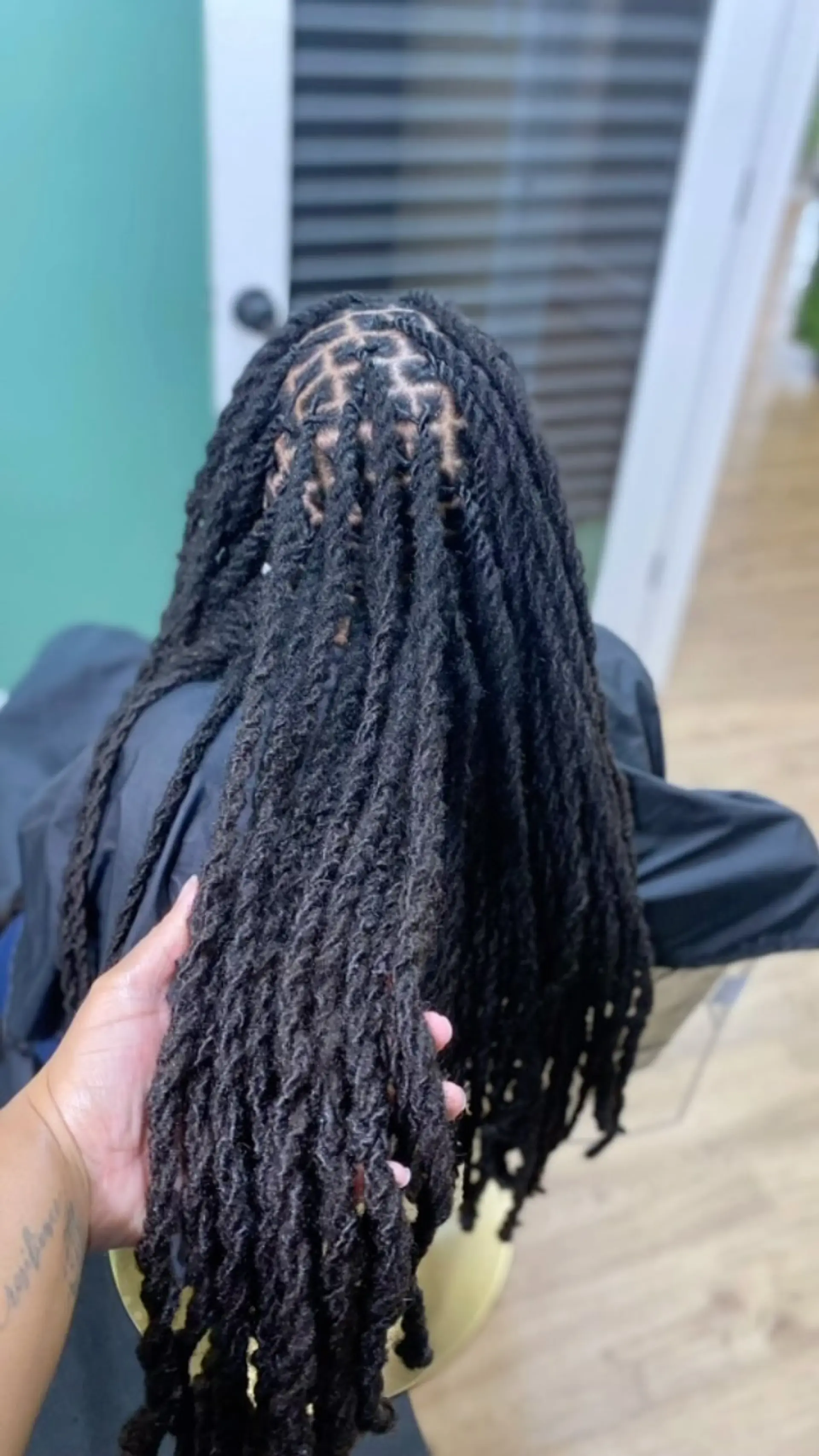 Long black dreadlocks freshly retwisted at the scalp and styled into uniform two-strand rope twists. 1