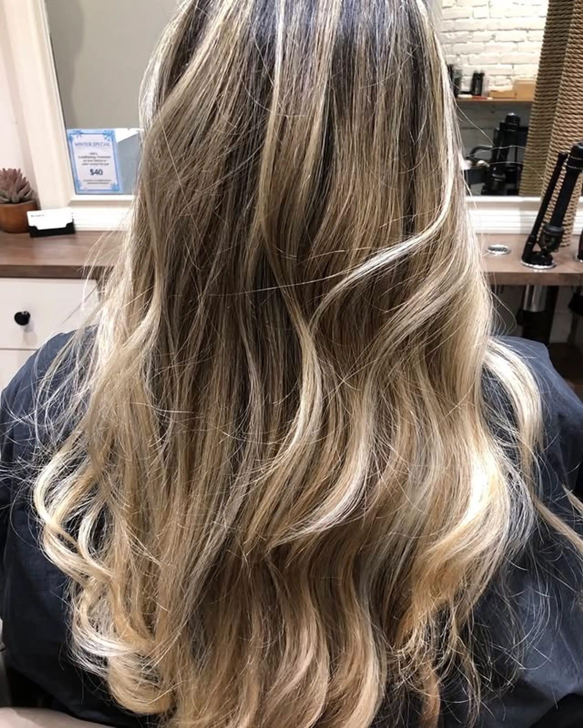 Long layered waves with a beachy blonde balayage. 1