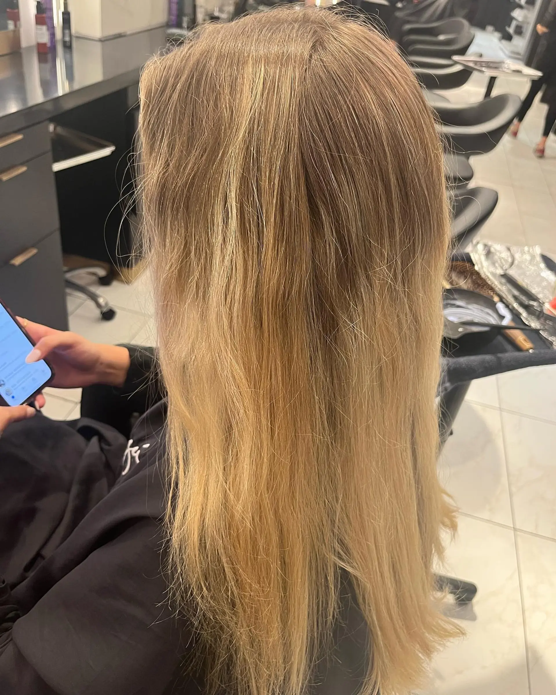 Long, wavy blonde hair styled with a balayage technique to create beach waves. 2