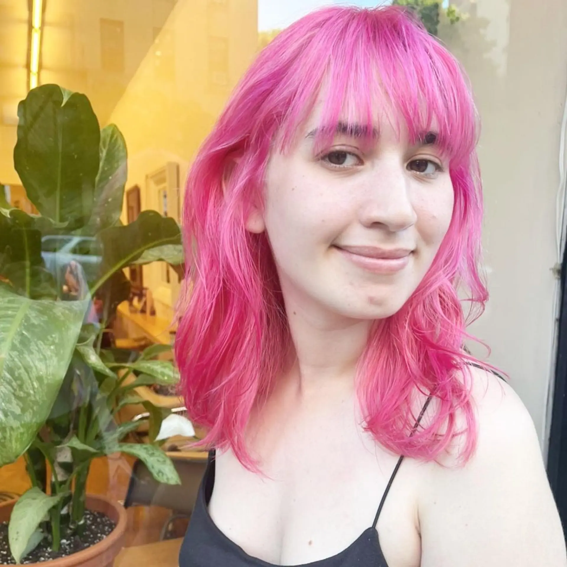 Medium-length, wavy hair with a vibrant pink color, featuring straight-across bangs and layered cuts that add texture and movement. New passion💓by @kotarohair.newyork 2