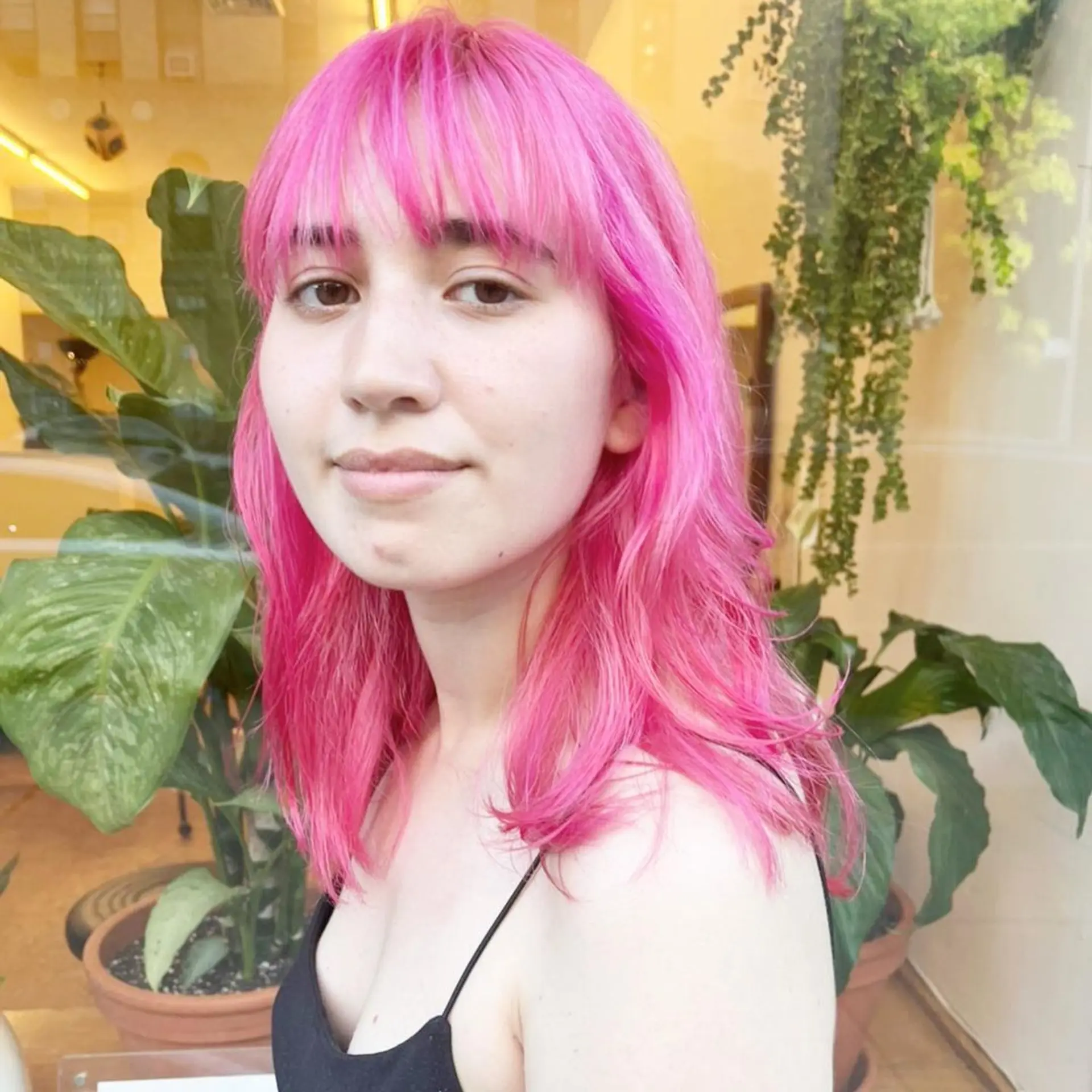 Medium-length, wavy hair with a vibrant pink color, featuring straight-across bangs and layered cuts that add texture and movement. New passion💓by @kotarohair.newyork 1