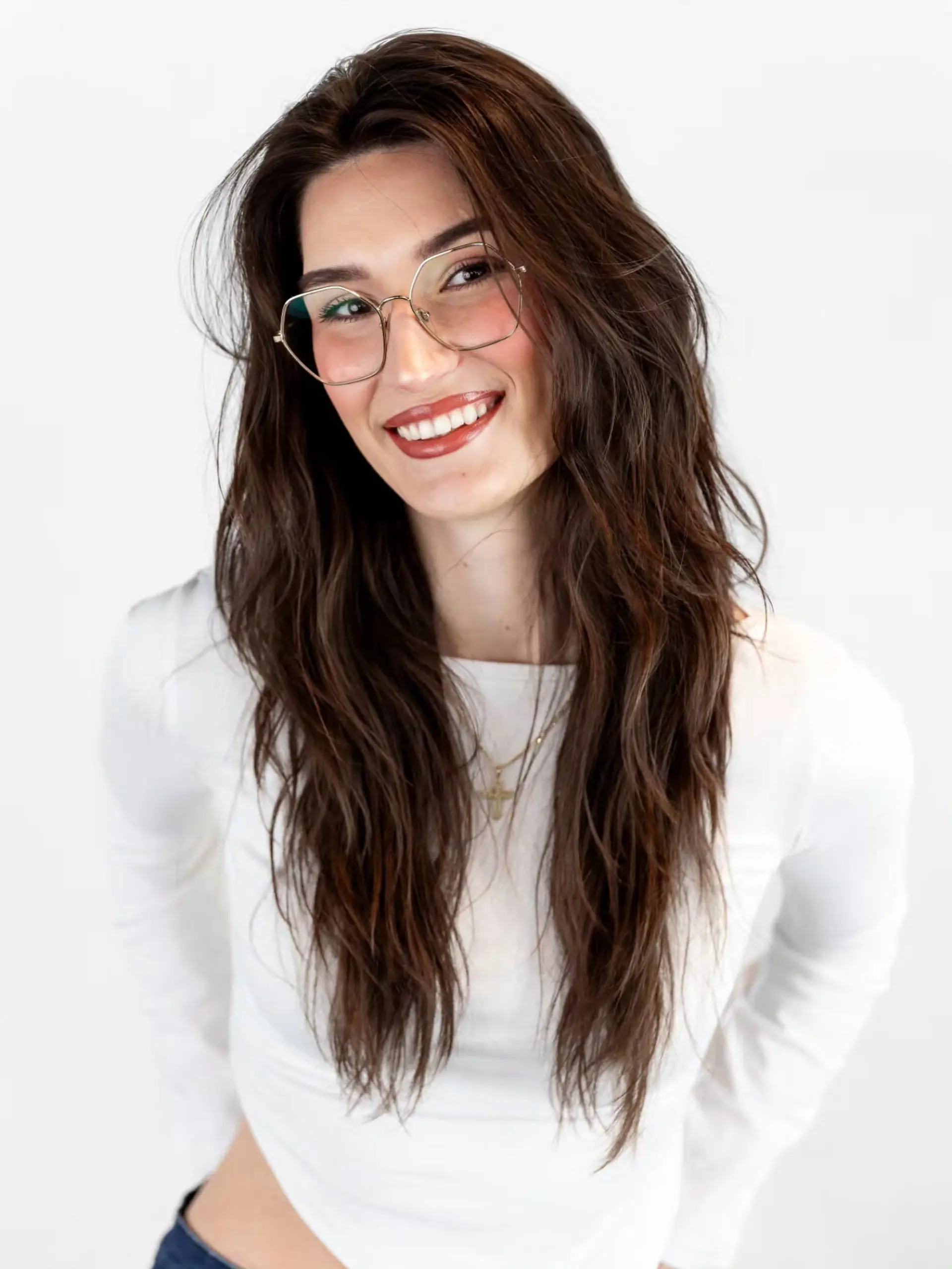 Long brunette hair styled in loose, tousled waves with face-framing layers. 1