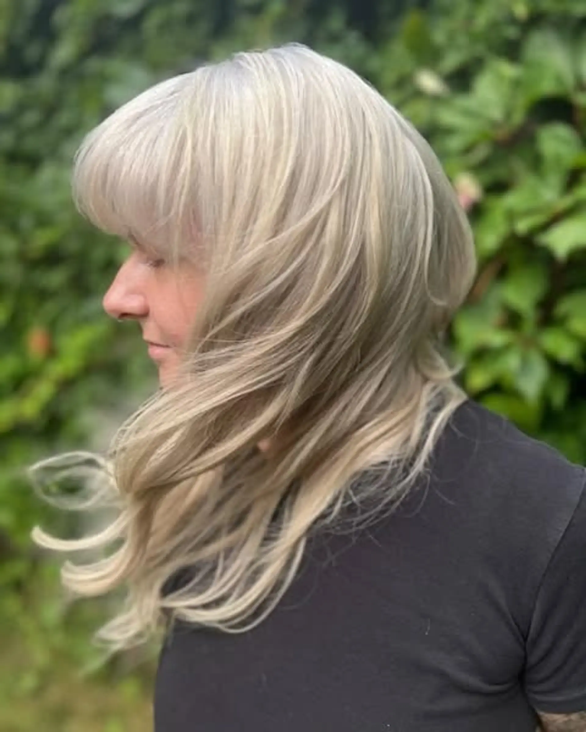 A modern shag haircut with layered texture and blunt bangs. 1