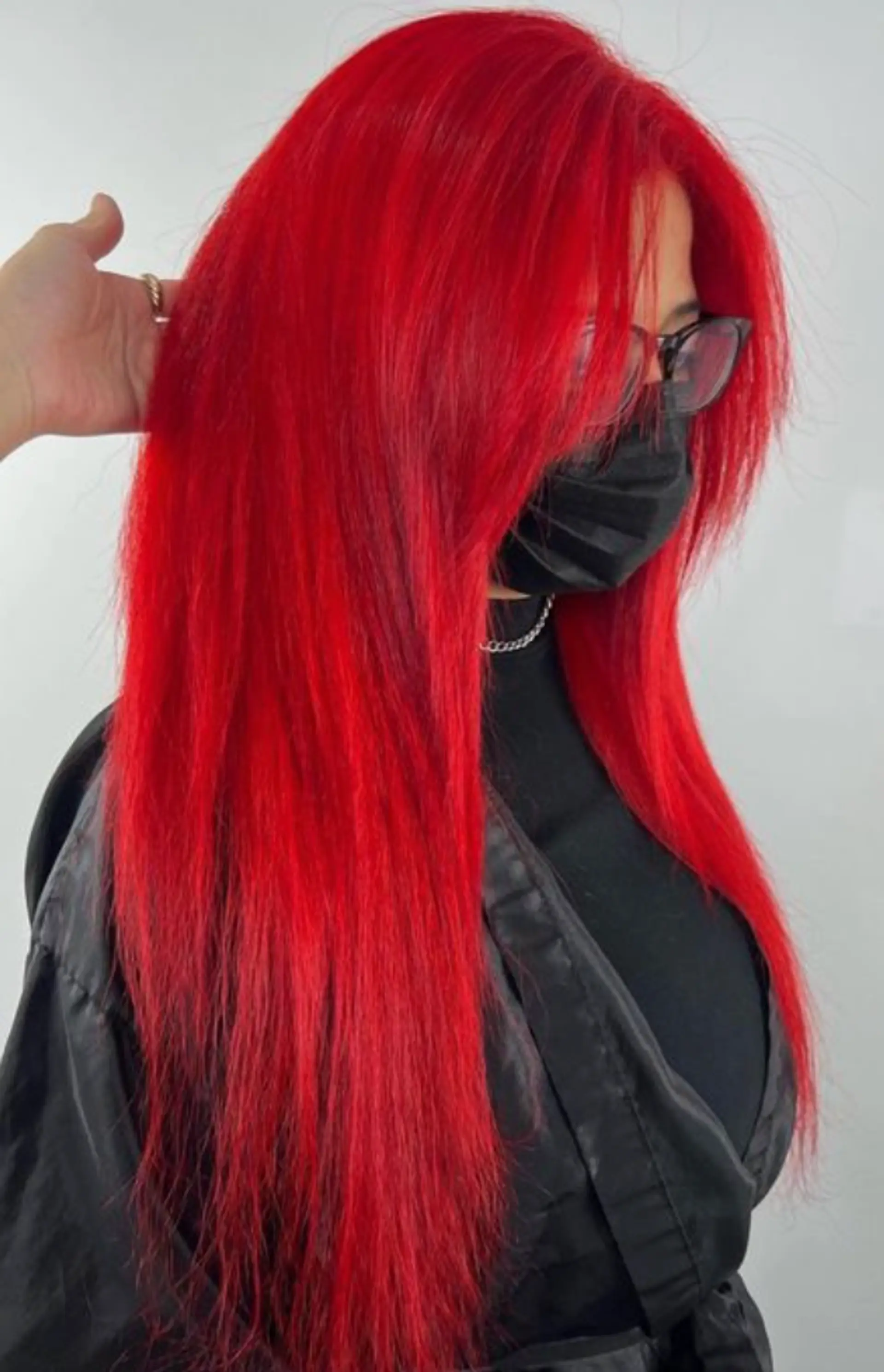 A stunning, very long straight hairstyle with a striking red color. The hair is meticulously styled, creating a smooth and sleek look. The vibrant red hue is bold and eye-catching, cascading down the back. The hair is full and voluminous, with a slight layering effect that adds dimension and movement. The ends are softly trimmed to create a polished finish. 1