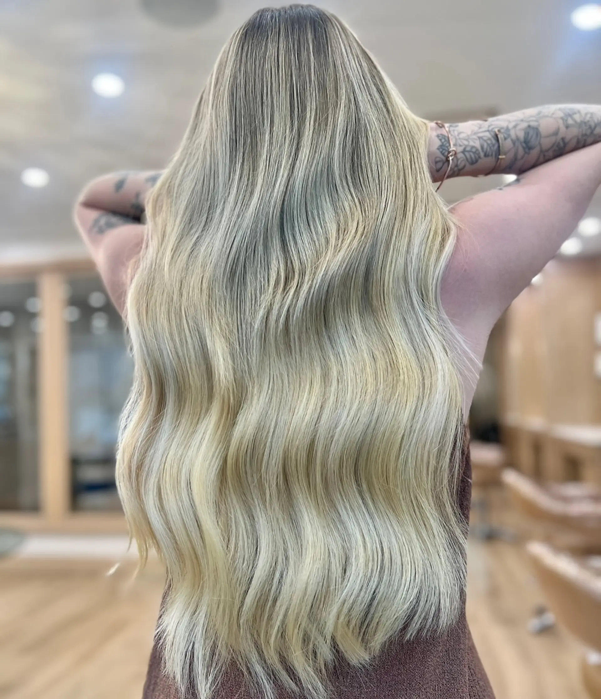 Very long, soft waves, styled in a loose flowing pattern.  The cut provides subtle layering to encourage volume and movement with a face frame. 1