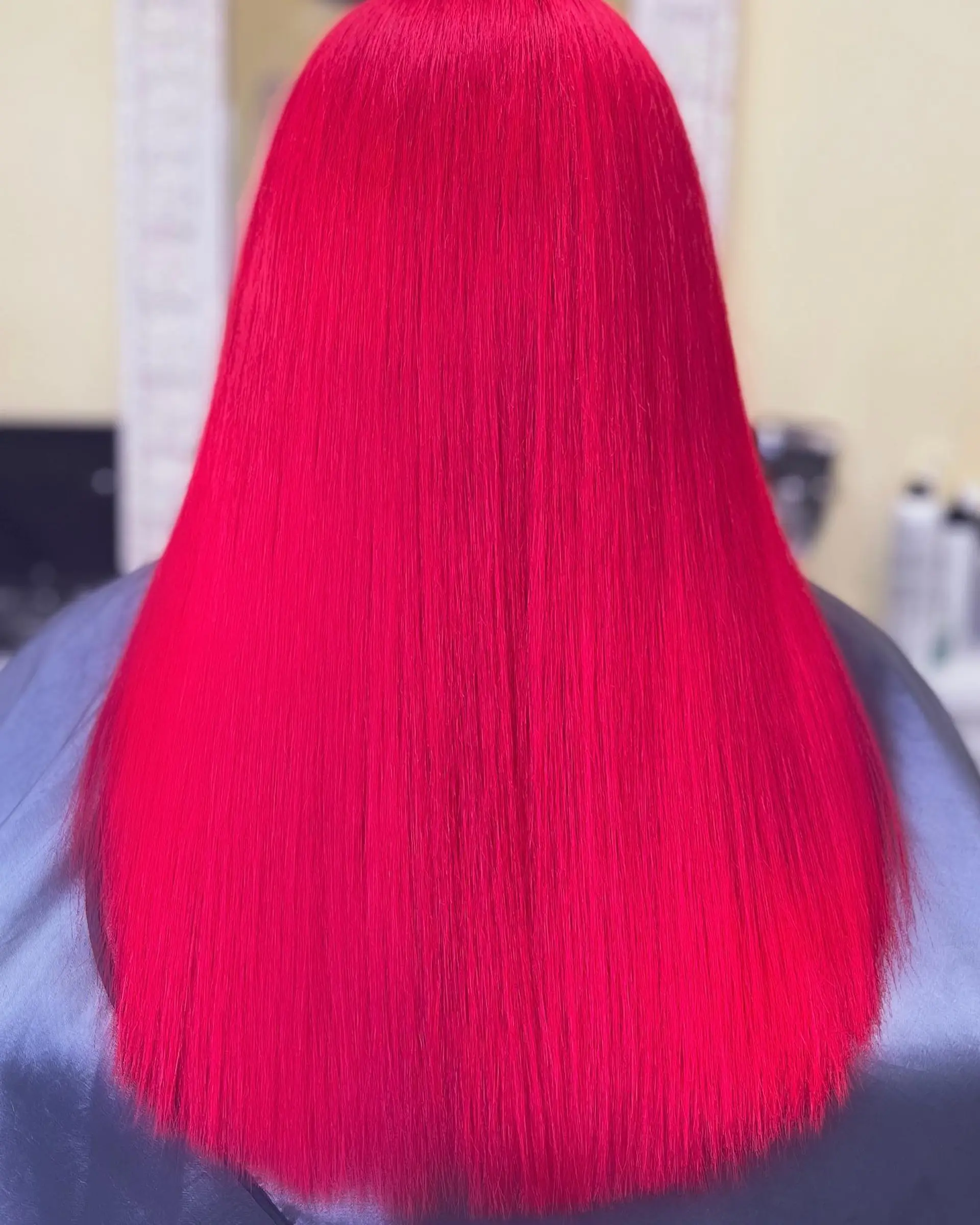 Long straight hair with a neon red color and contrasting pink money piece highlights. 2