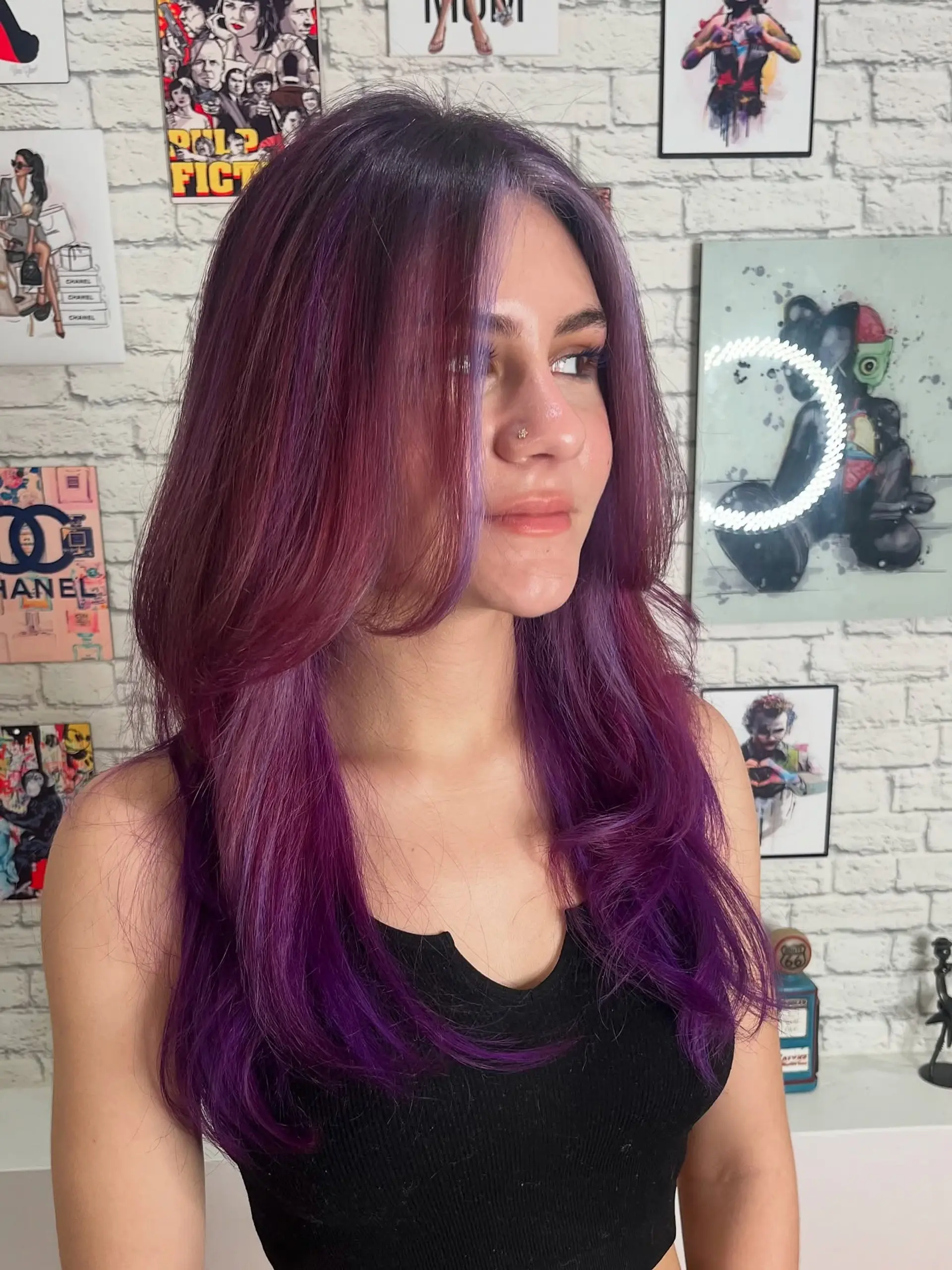 A medium-length layered haircut with face-framing layers, styled with a vibrant purple and burgundy color combination. 1