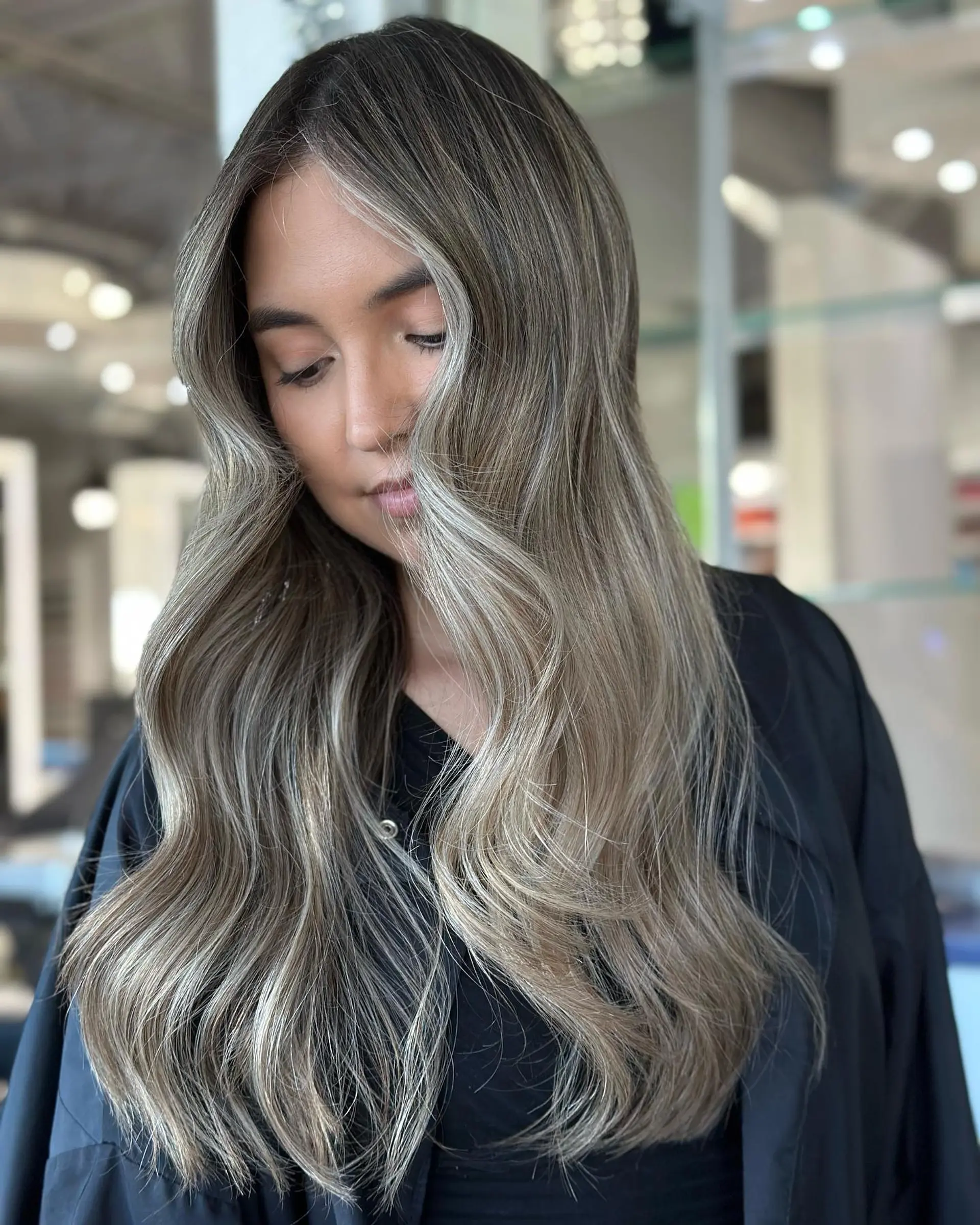 Long, wavy hair with a seamless ash blonde balayage. 1