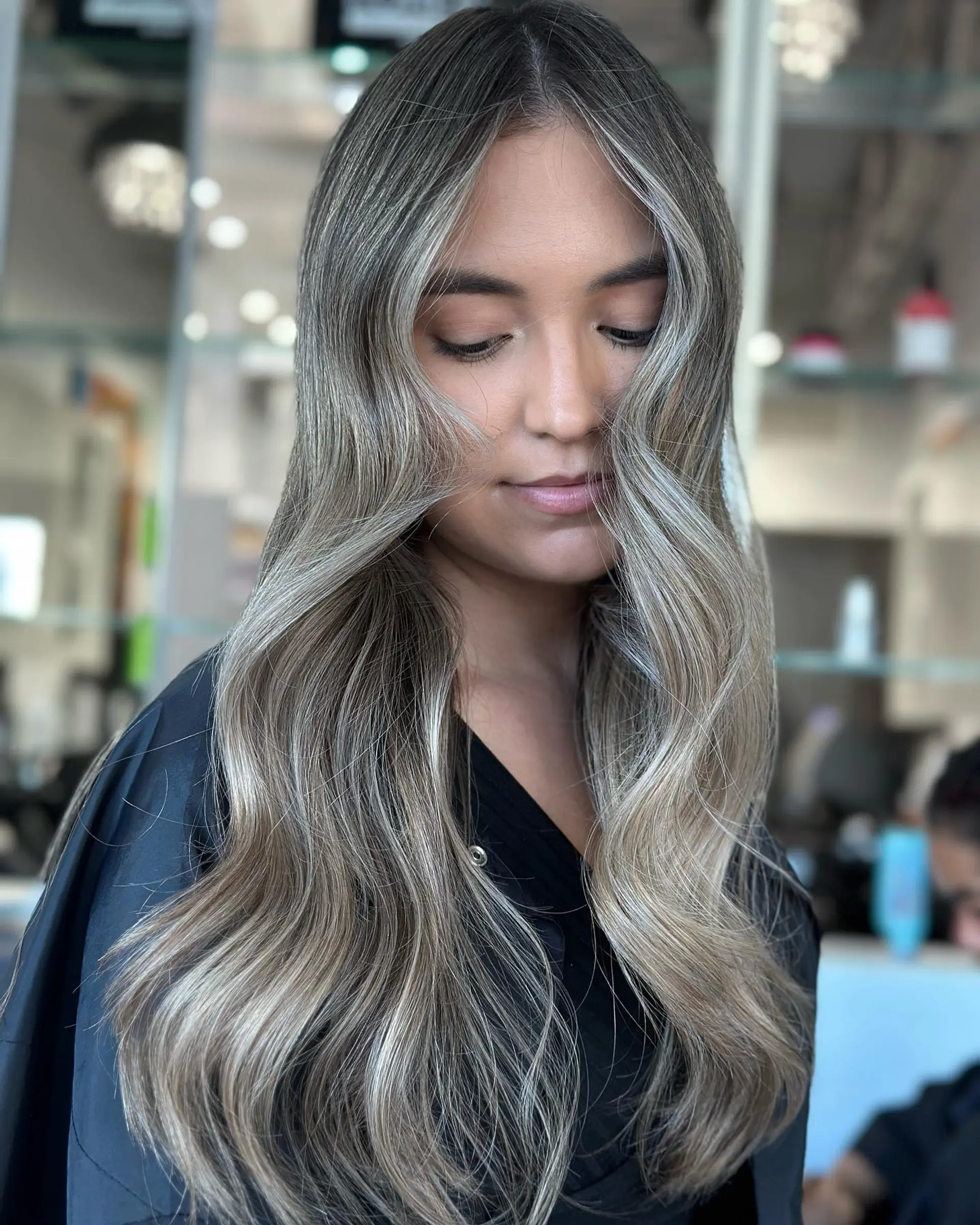 Long, wavy hair with a seamless ash blonde balayage. 2