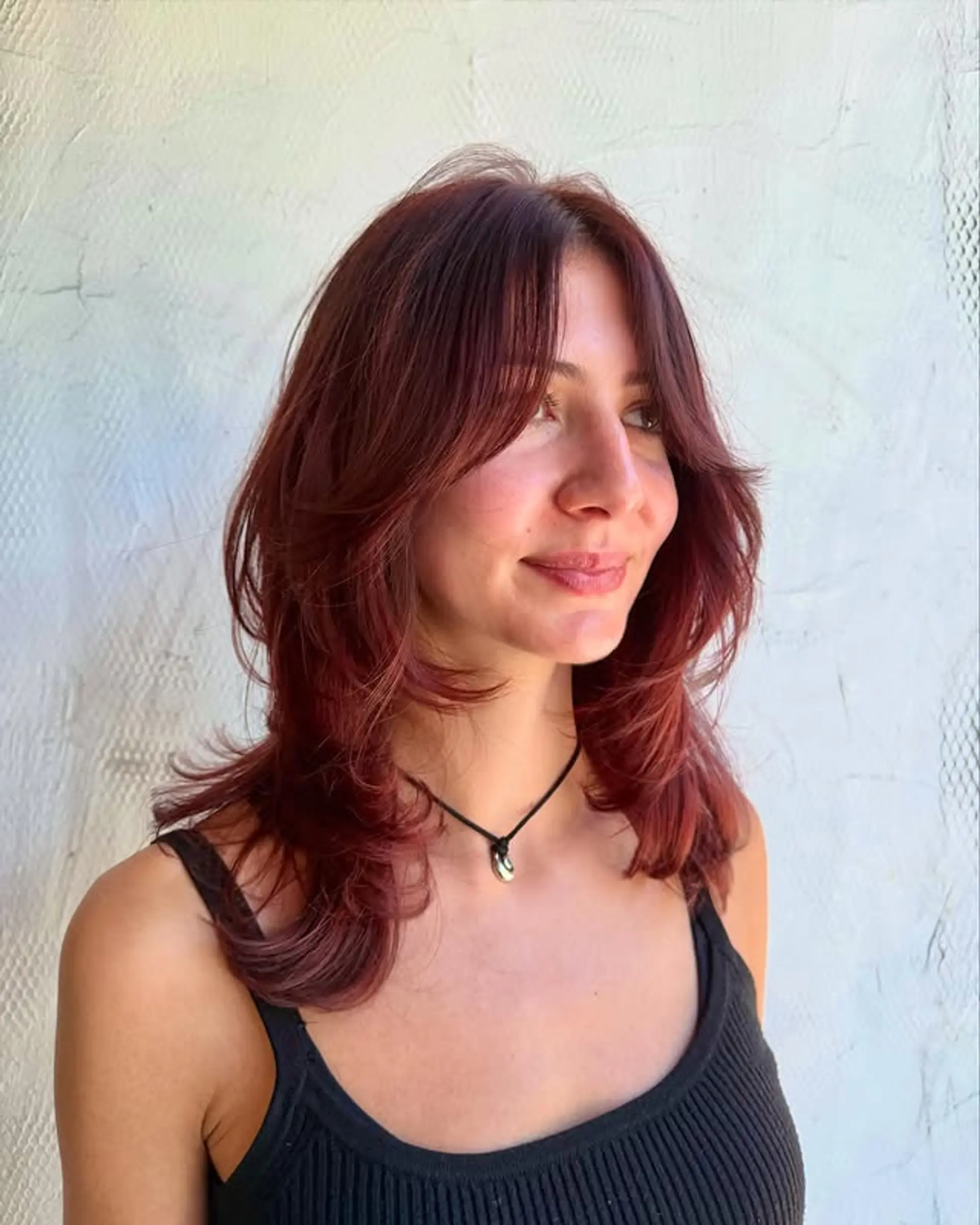 A trendy layered shag haircut with curtain bangs, offering a textured and effortless style. 1