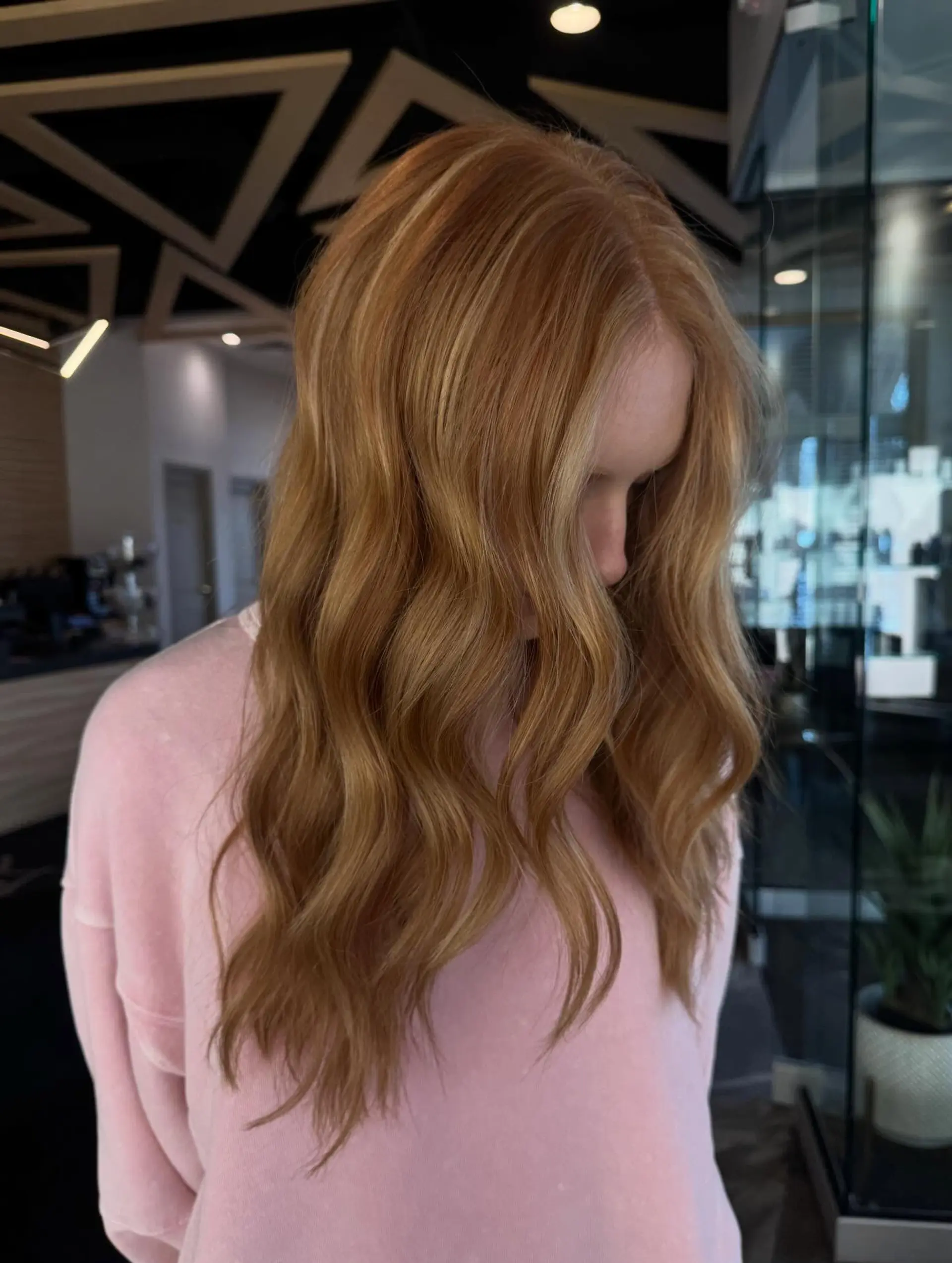 Long hair styled in soft, defined waves featuring multidimensional warm copper and golden highlights. 1