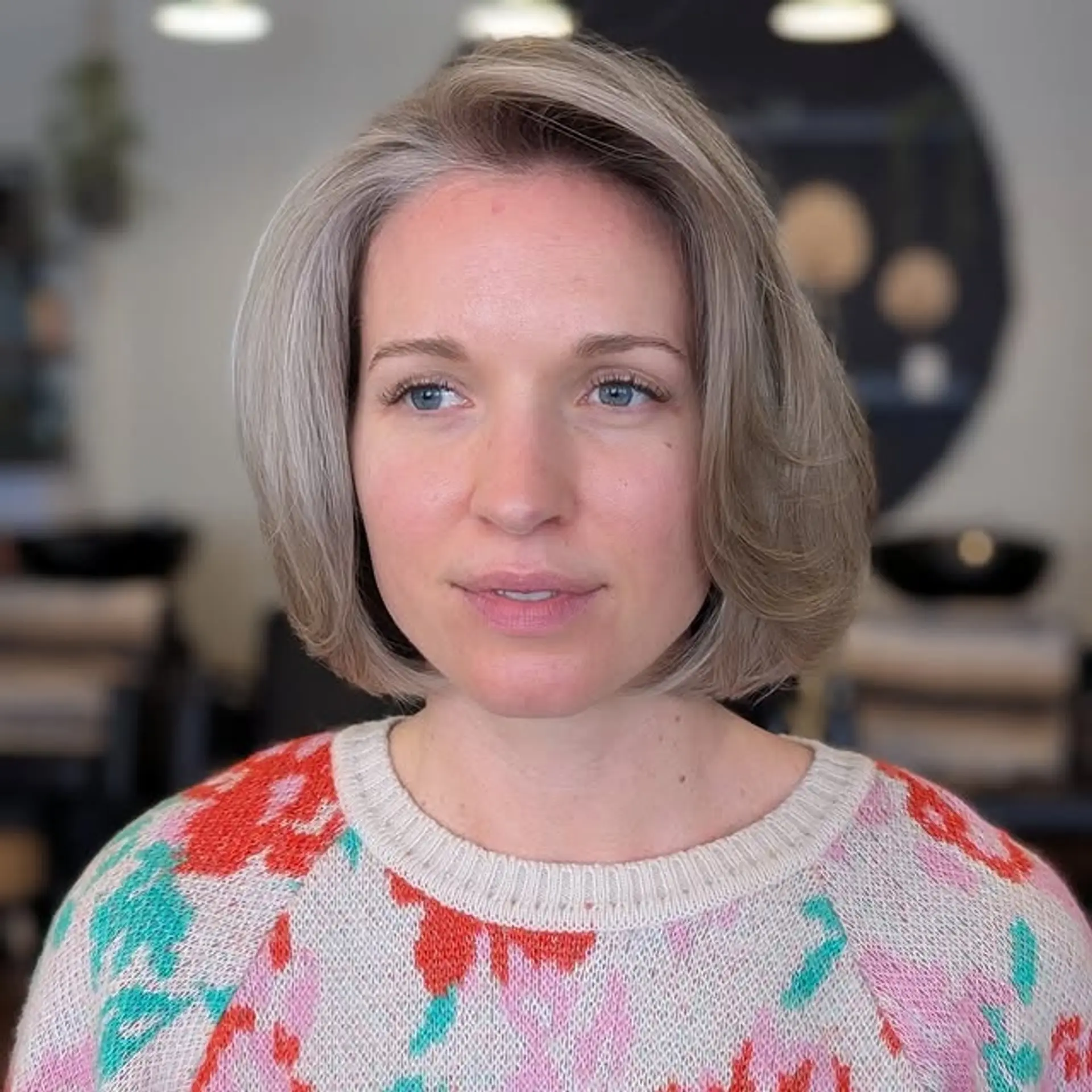 A classic chin-length bob with subtle layering and soft silver highlights. 1