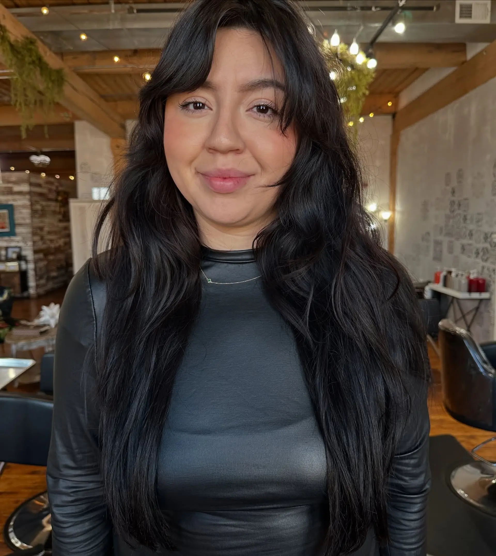 Long, straight hairstyle with curtain bangs and face-framing layers. 2