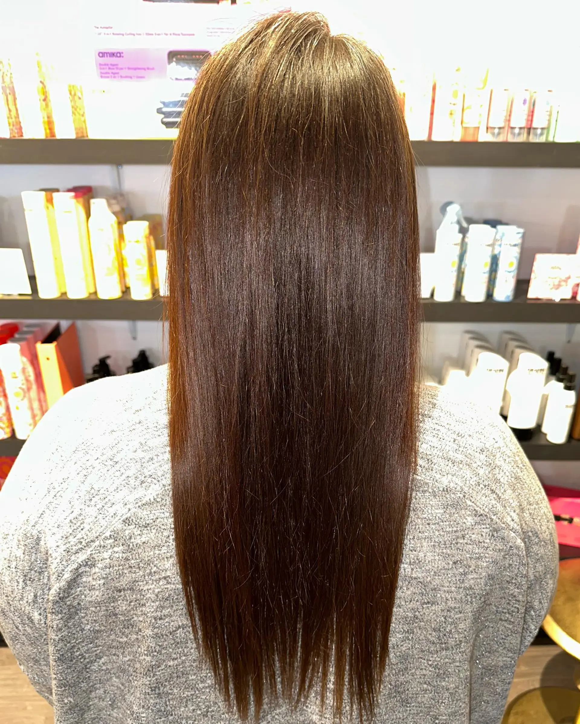 Sleek, straight brunette hair falling past the shoulders with a glossy, frizz-free finish. 1