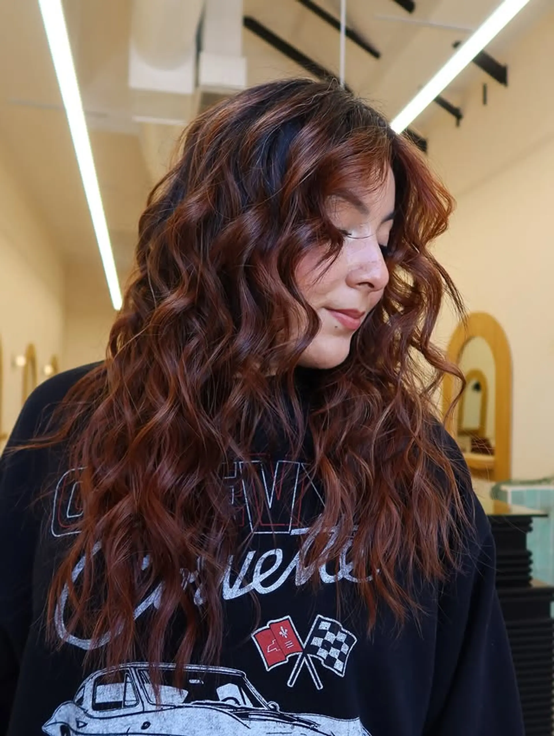 Long, wavy hairstyle with a copper red bronde balayage. 1