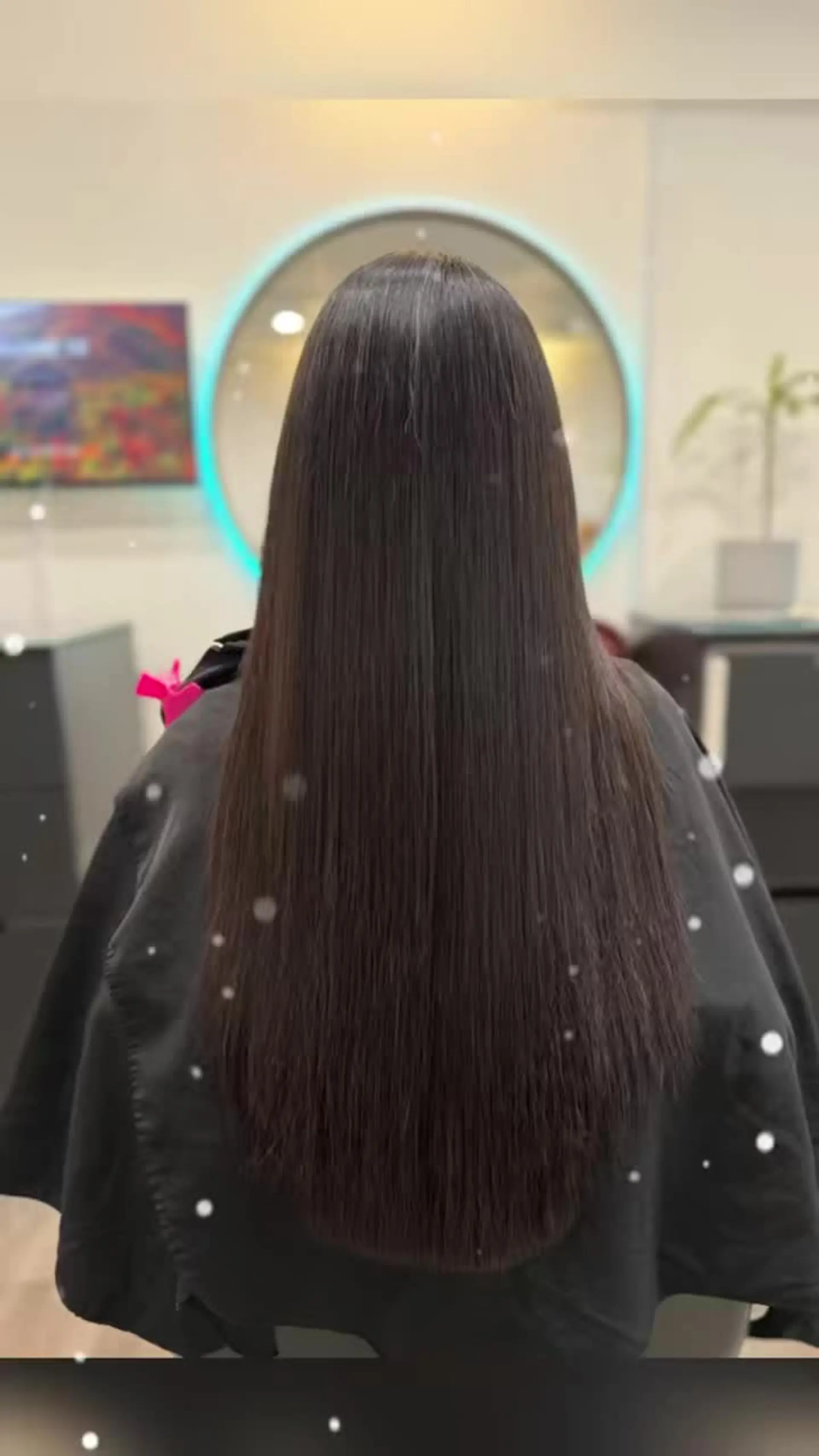 Sleek and glossy pin-straight long dark hair with a smooth, frizz-free finish. 1