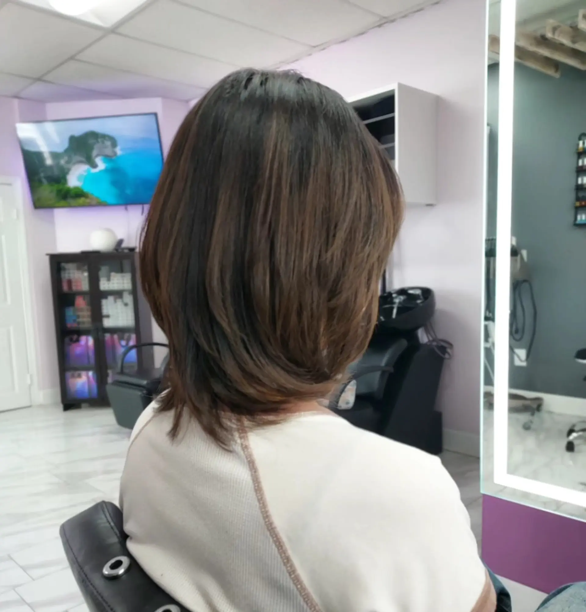 A shoulder-length layered haircut with soft inward-curving ends and gentle natural movement. 1
