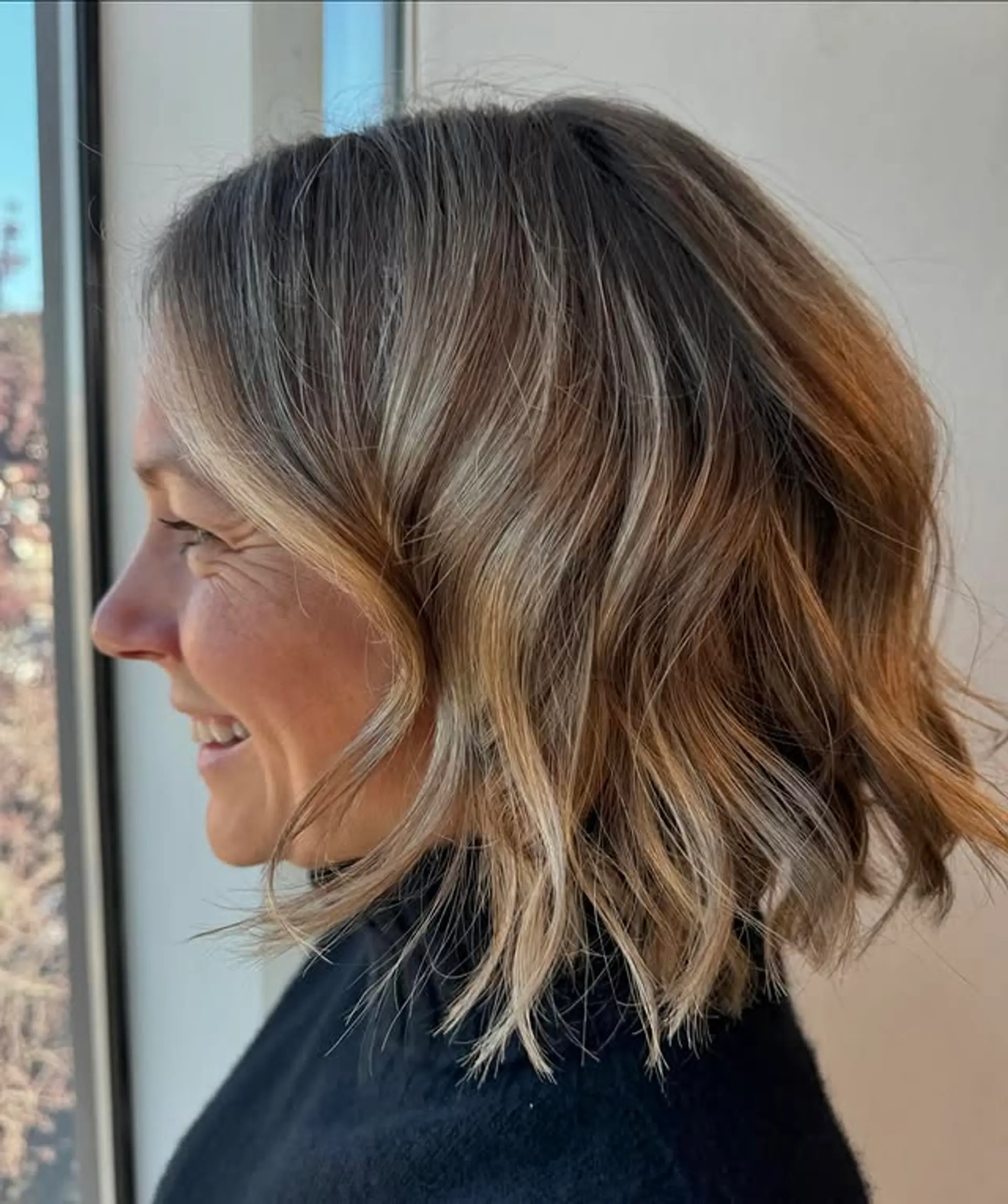 A wavy bob with a bronde balayage, creating a dimensional and stylish look. 1