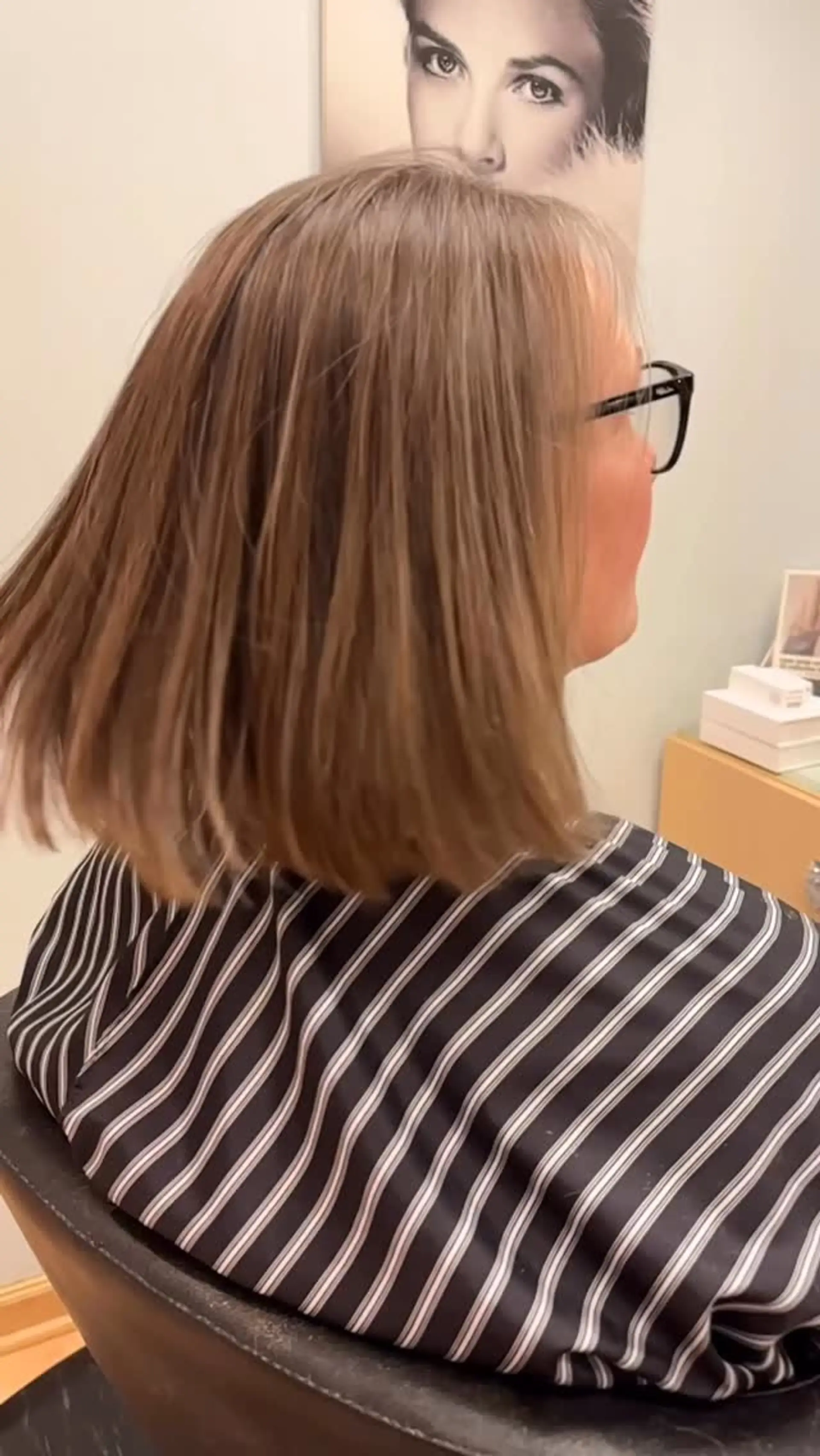 A sleek, shoulder-length blunt bob with subtle interior texture and a smooth finish. 1