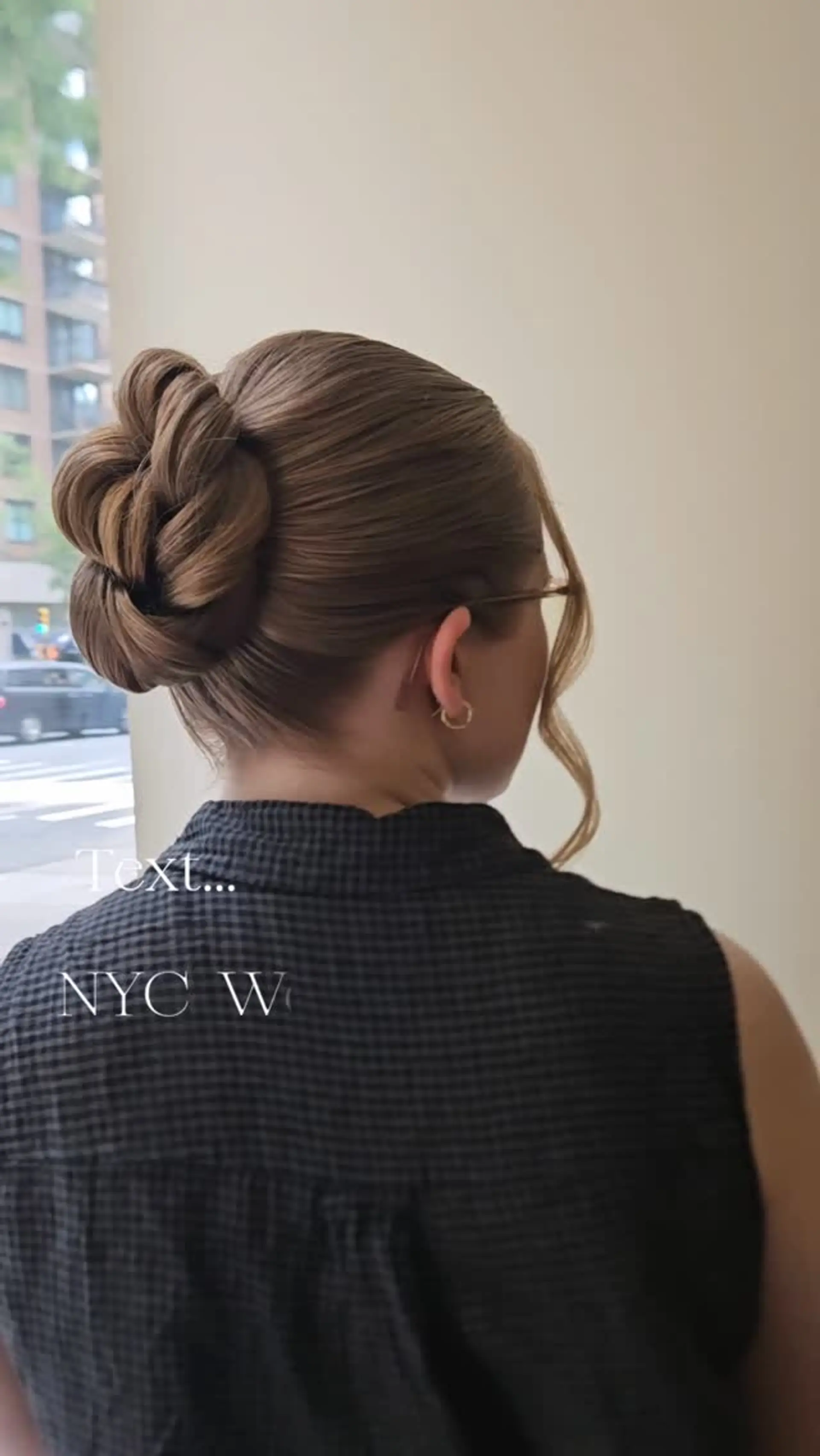 A sleek and elegant formal updo featuring a sculpted twisted bun with a soft face-framing tendril. 1