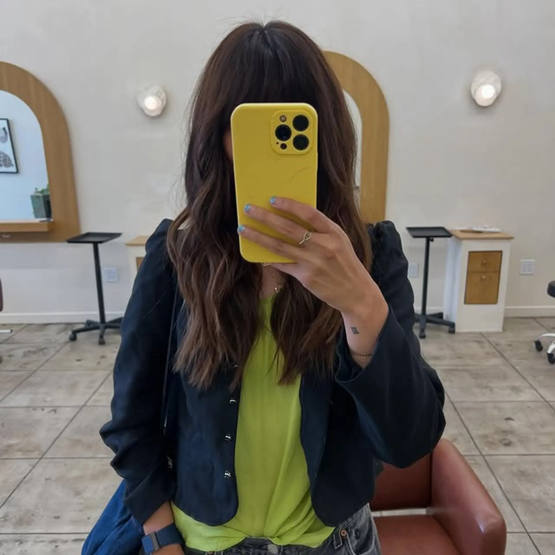 This is a medium-length shag haircut with curtain bangs and face-framing layers. 1