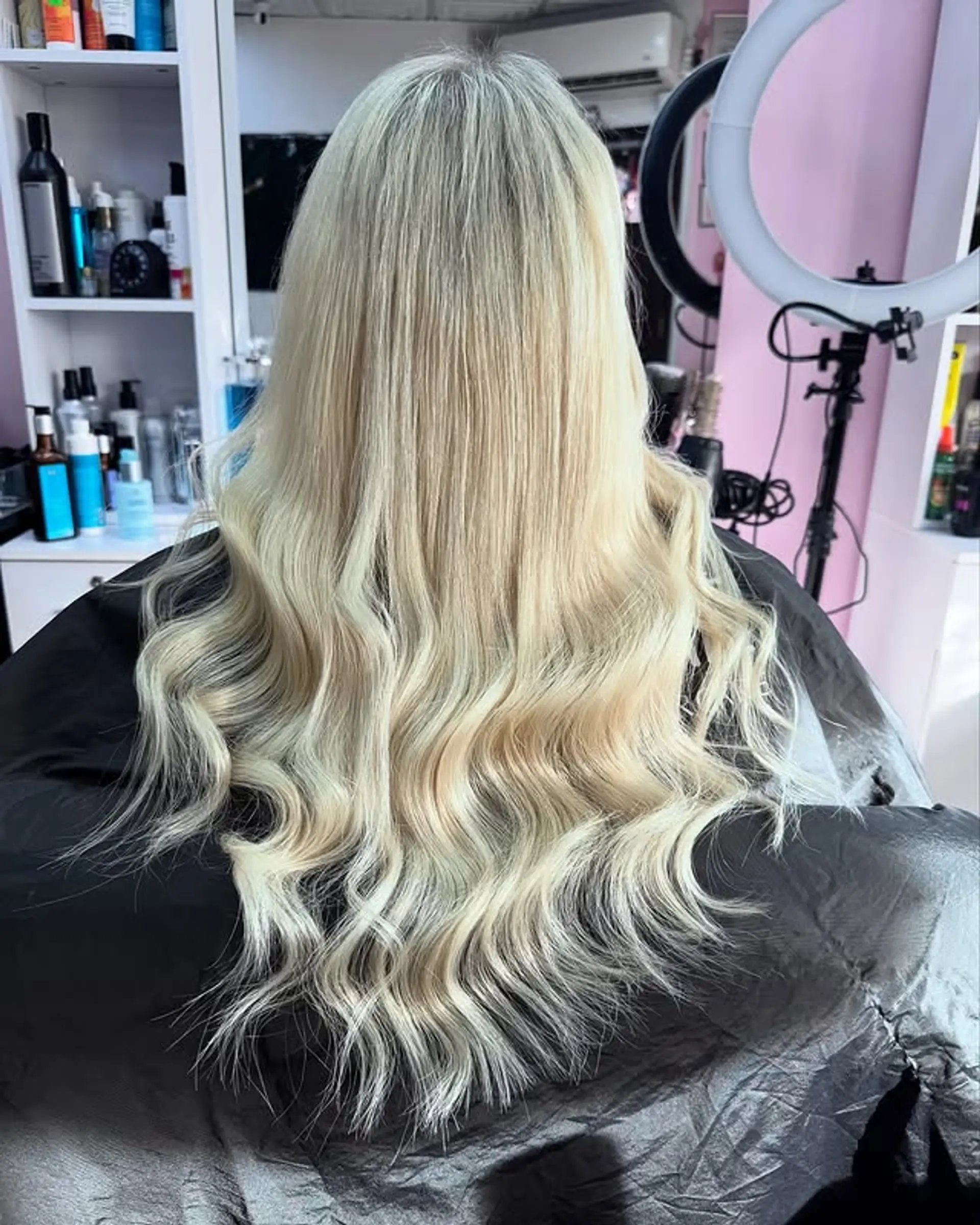 Long wavy blonde hair with extensions, creating a voluminous and glamorous look. 1