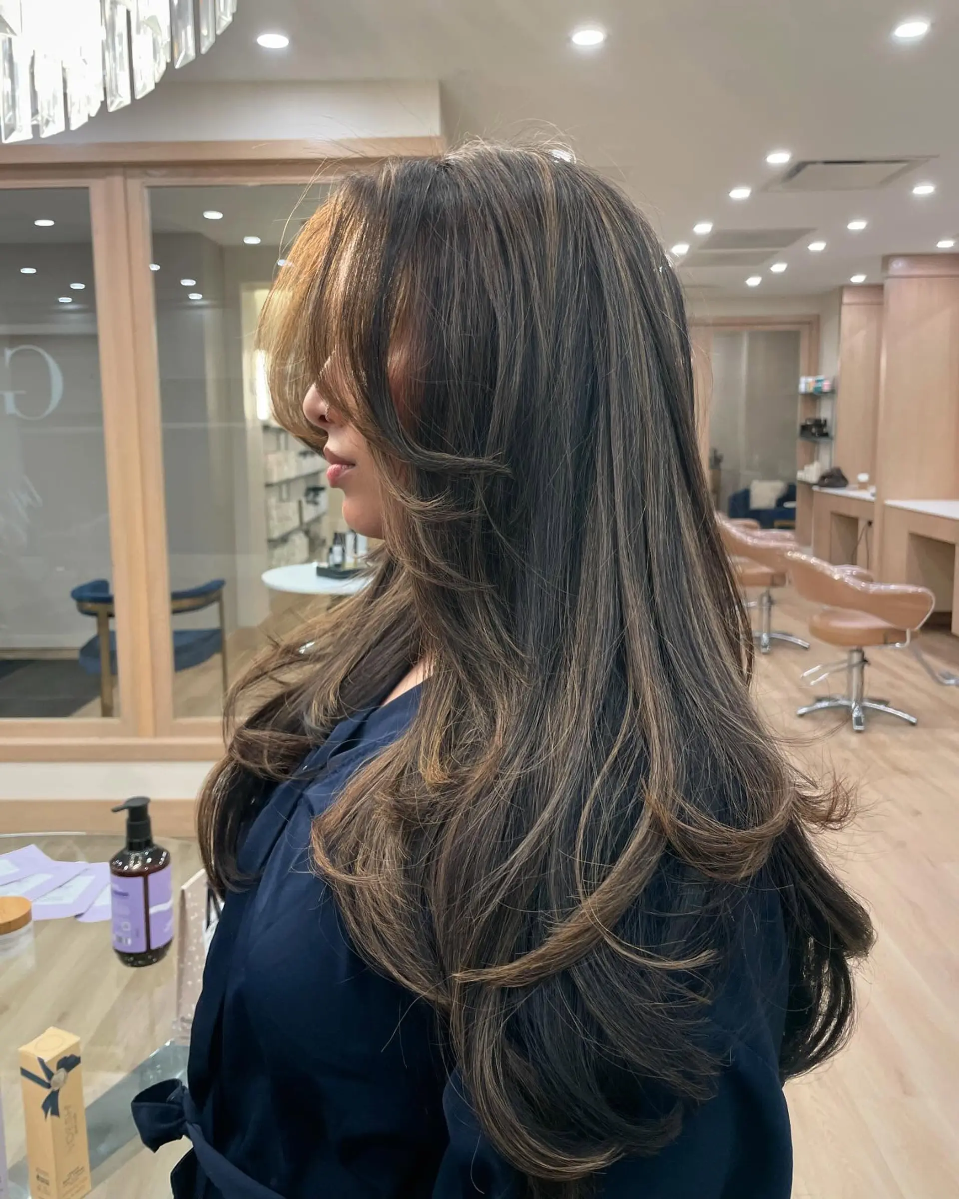 Long, wavy brunette hair with caramel balayage highlights and face-framing layers. 1