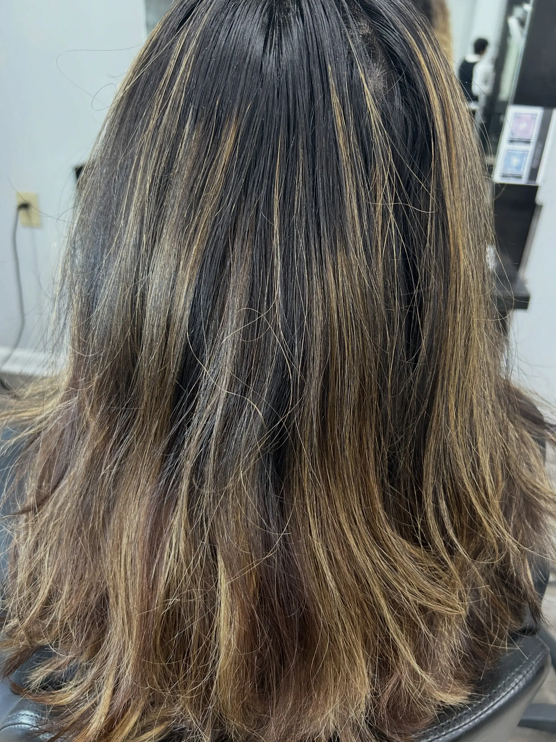 Medium-length dark brown hair accented with finely blended golden caramel highlights. 1
