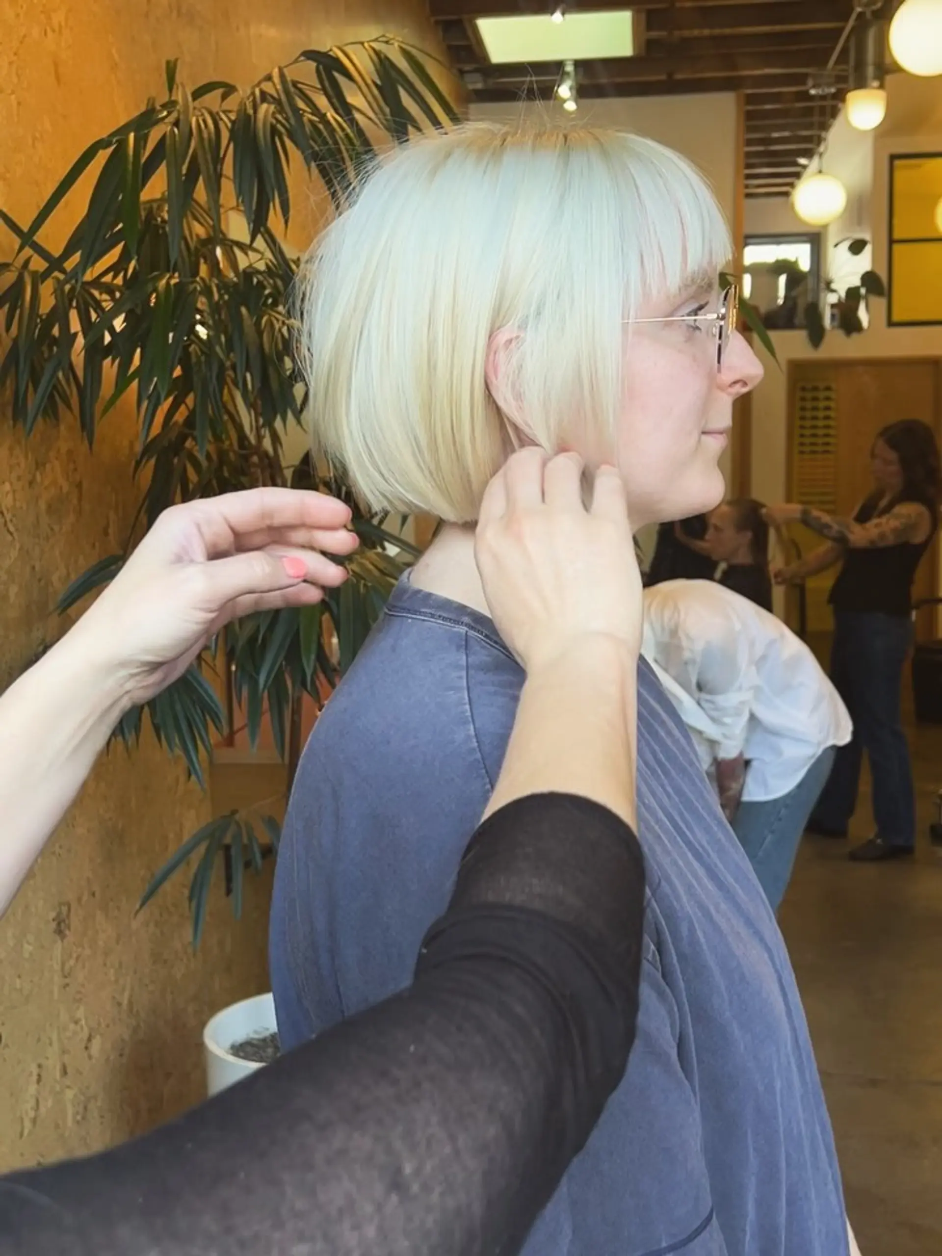 A sharp platinum blonde blunt bob with straight bangs. 1