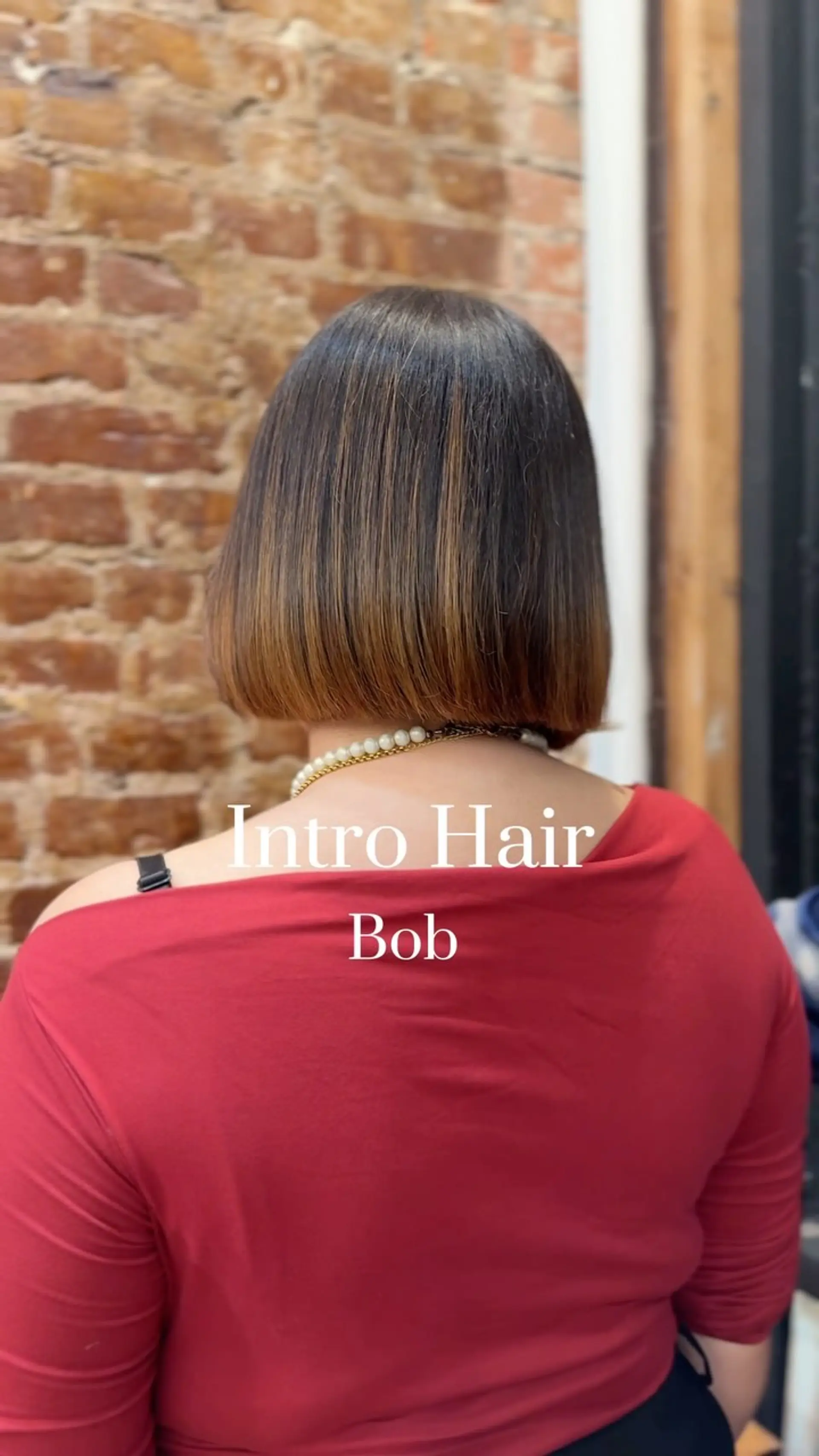 A precise, neck-length blunt bob styled smooth and straight, showing subtle warm brown ombre highlights. 1