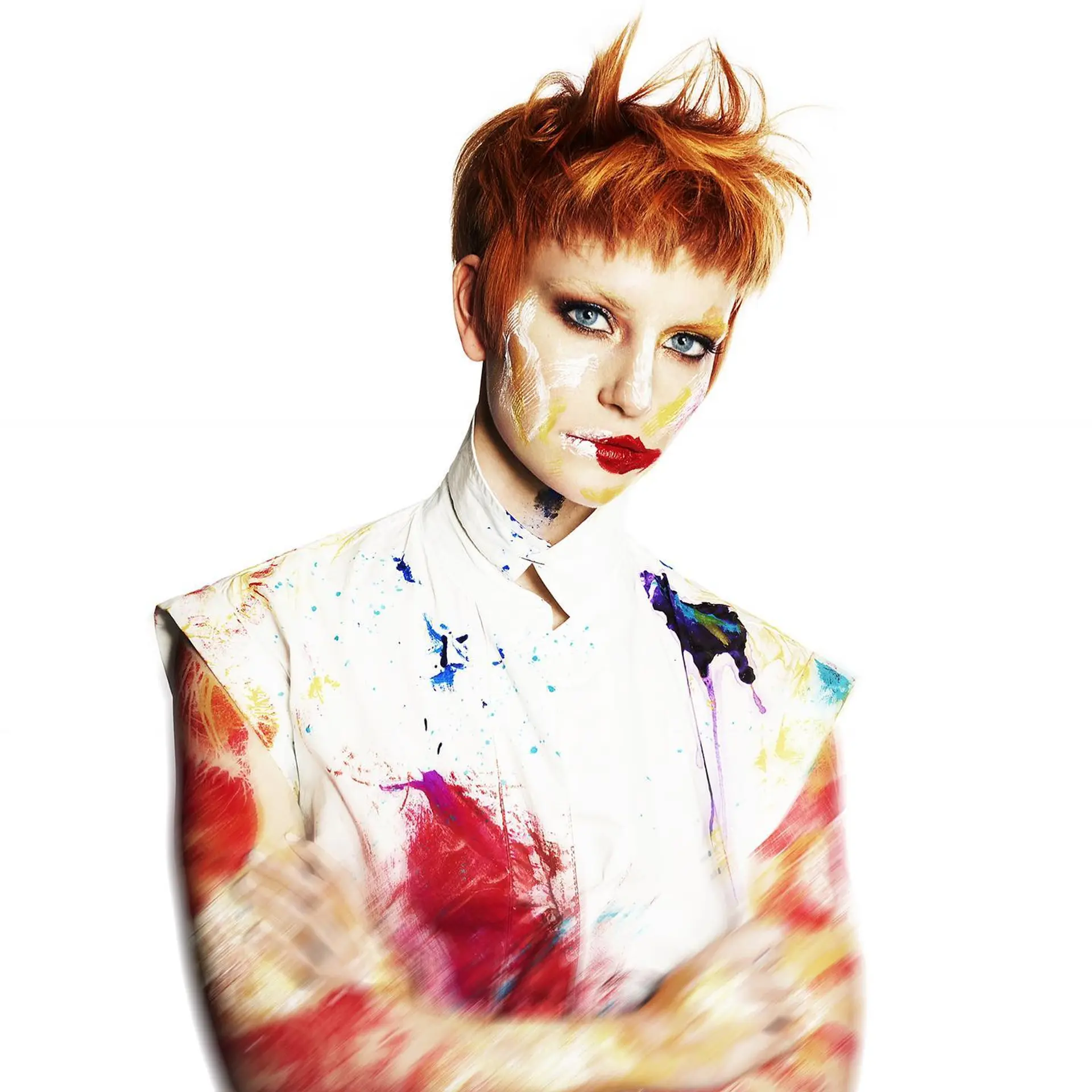 A bold copper-orange pixie cut featuring short, textured fringe and spiky layers styled upward at the crown. 1