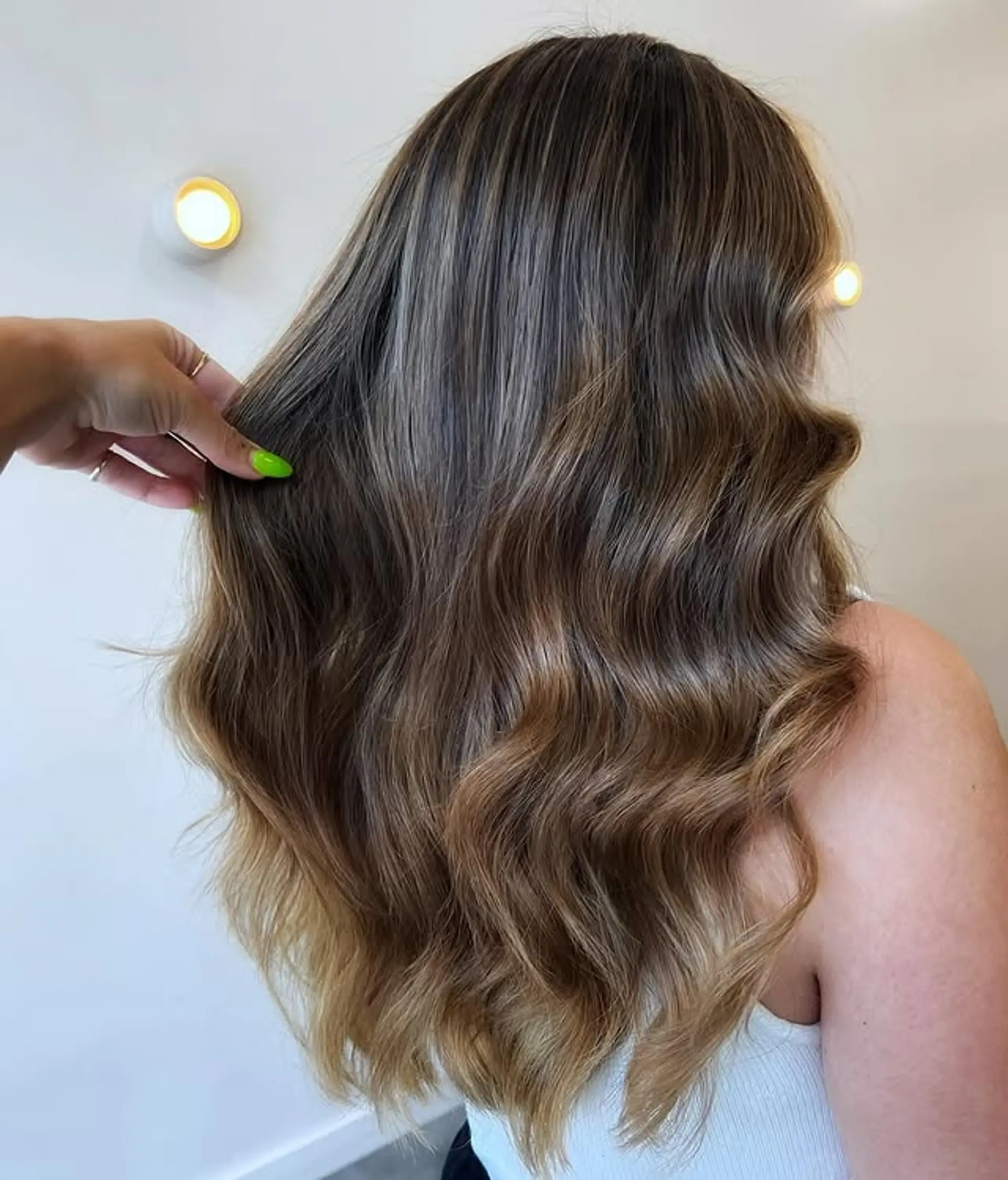 Long wavy hairstyle with a caramel swirl balayage and face-framing highlights. 1