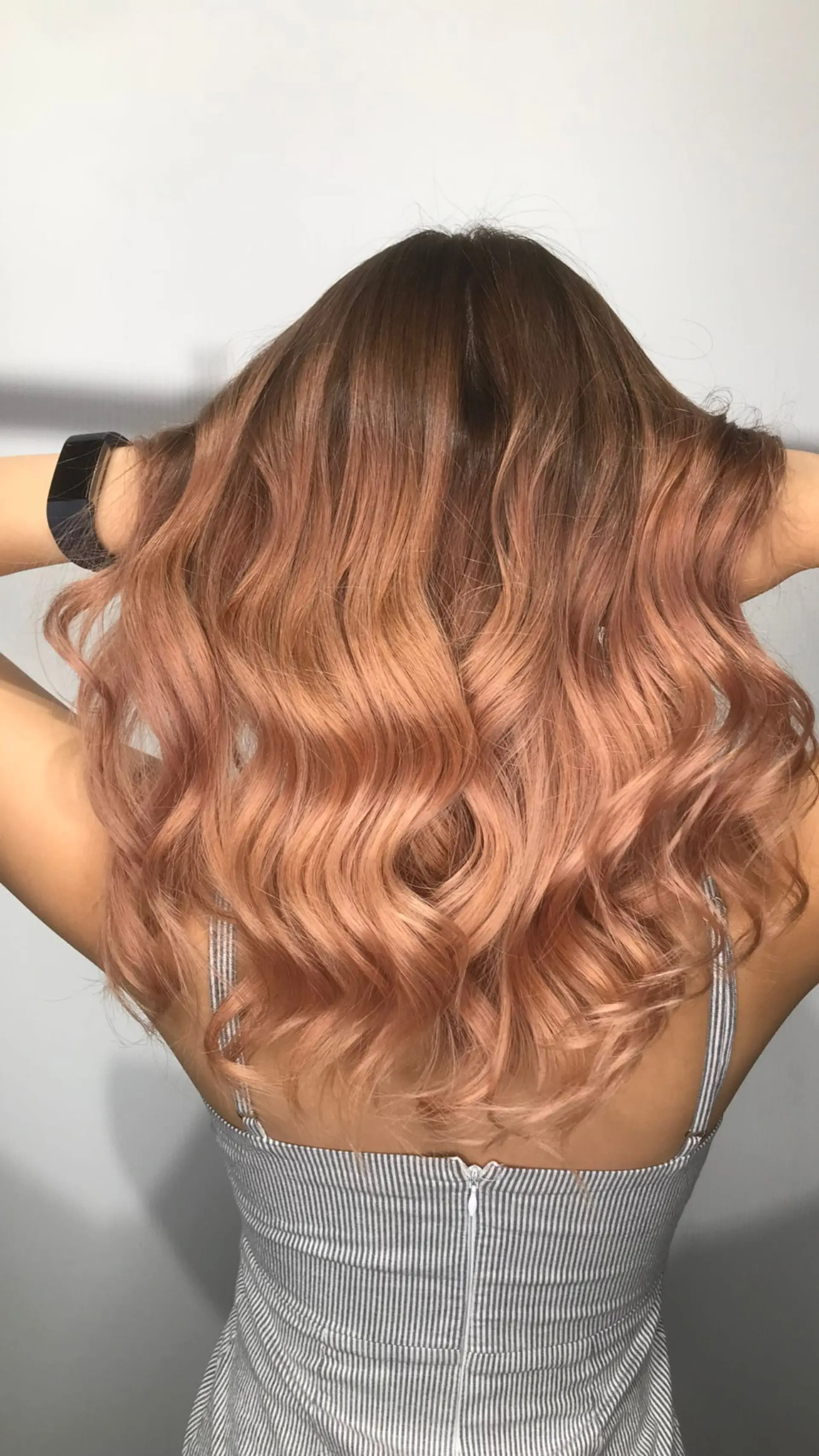 Long wavy hair with a rose gold ombre effect. 1