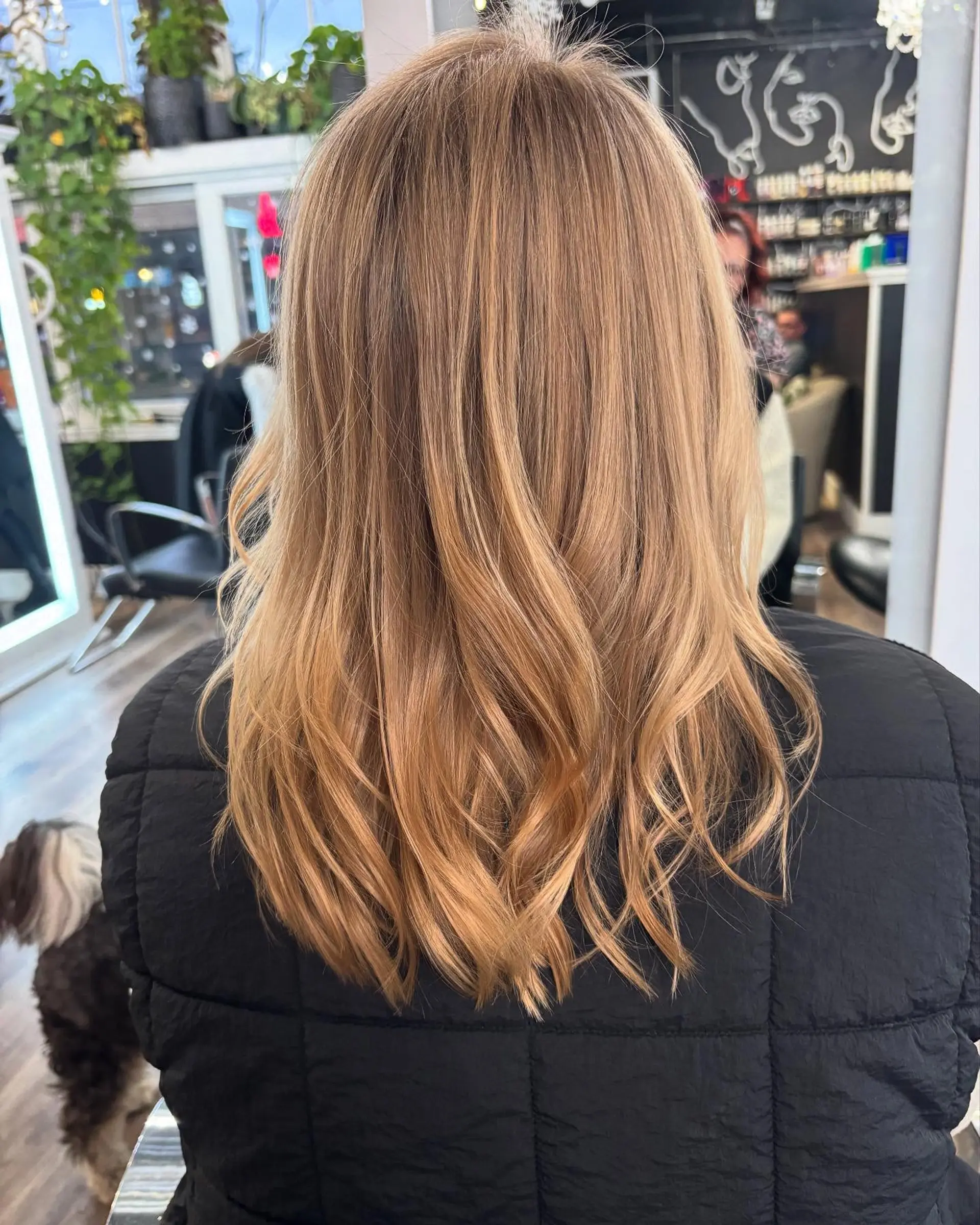 Warm honey blonde hair styled with soft, flowing waves and dimensional tones. 1