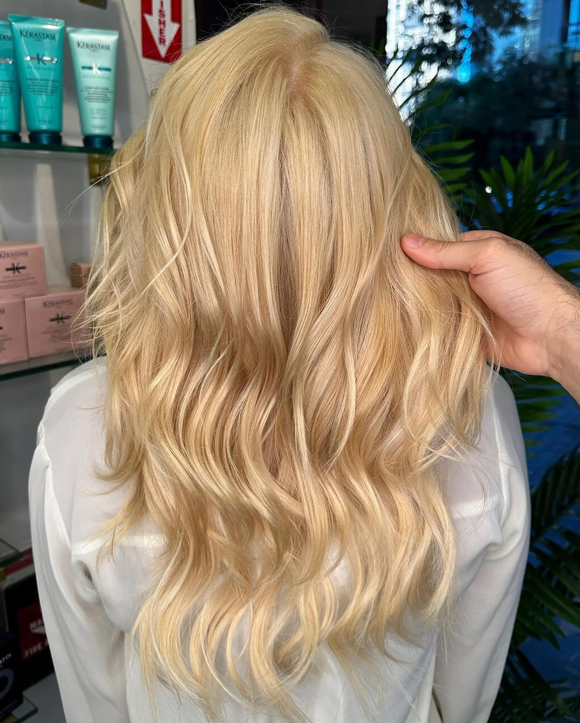 A long, wavy blonde hairstyle with loose, natural waves creating a soft texture and a warm, sunlit glow. 1