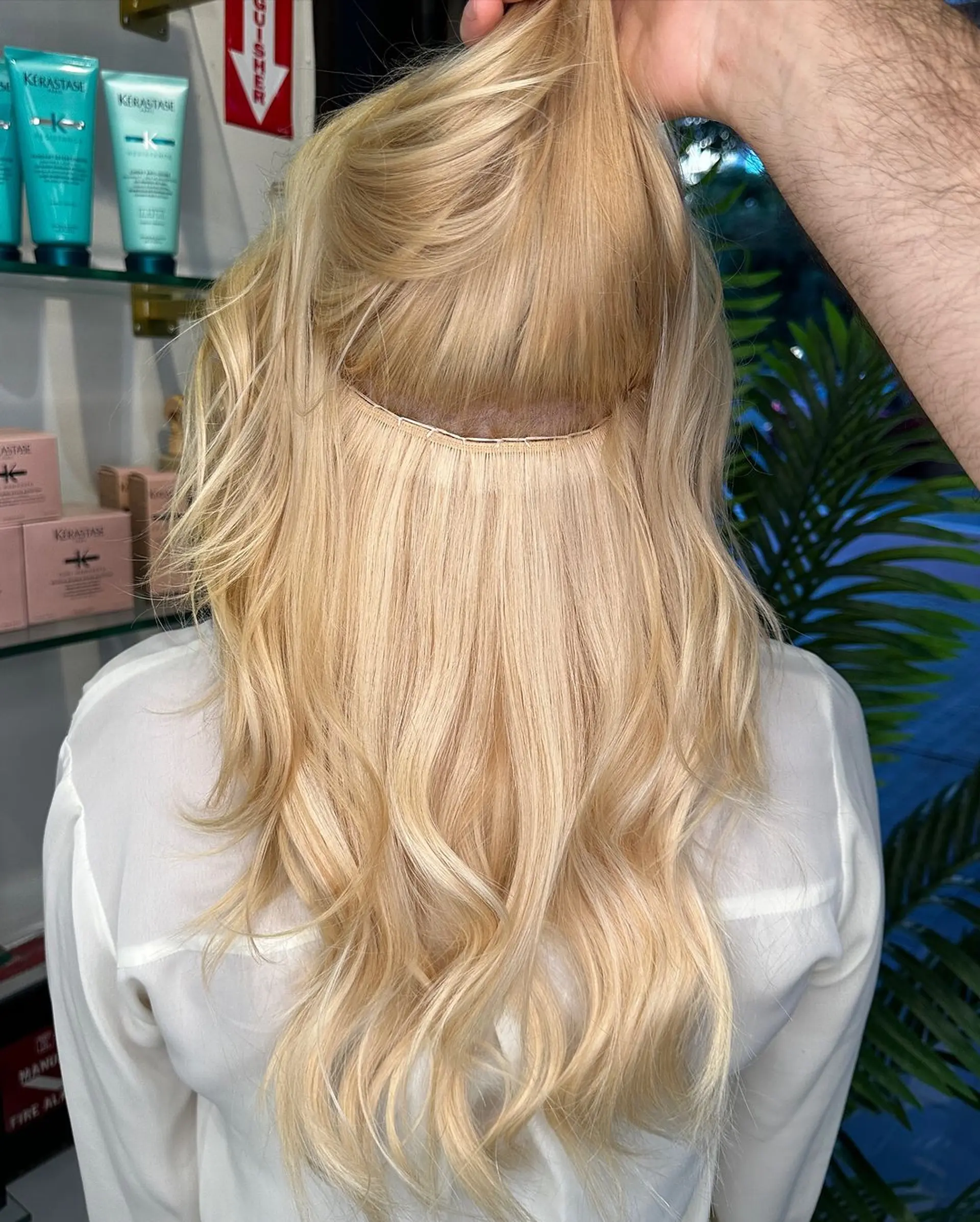 A long, wavy blonde hairstyle with loose, natural waves creating a soft texture and a warm, sunlit glow. 2