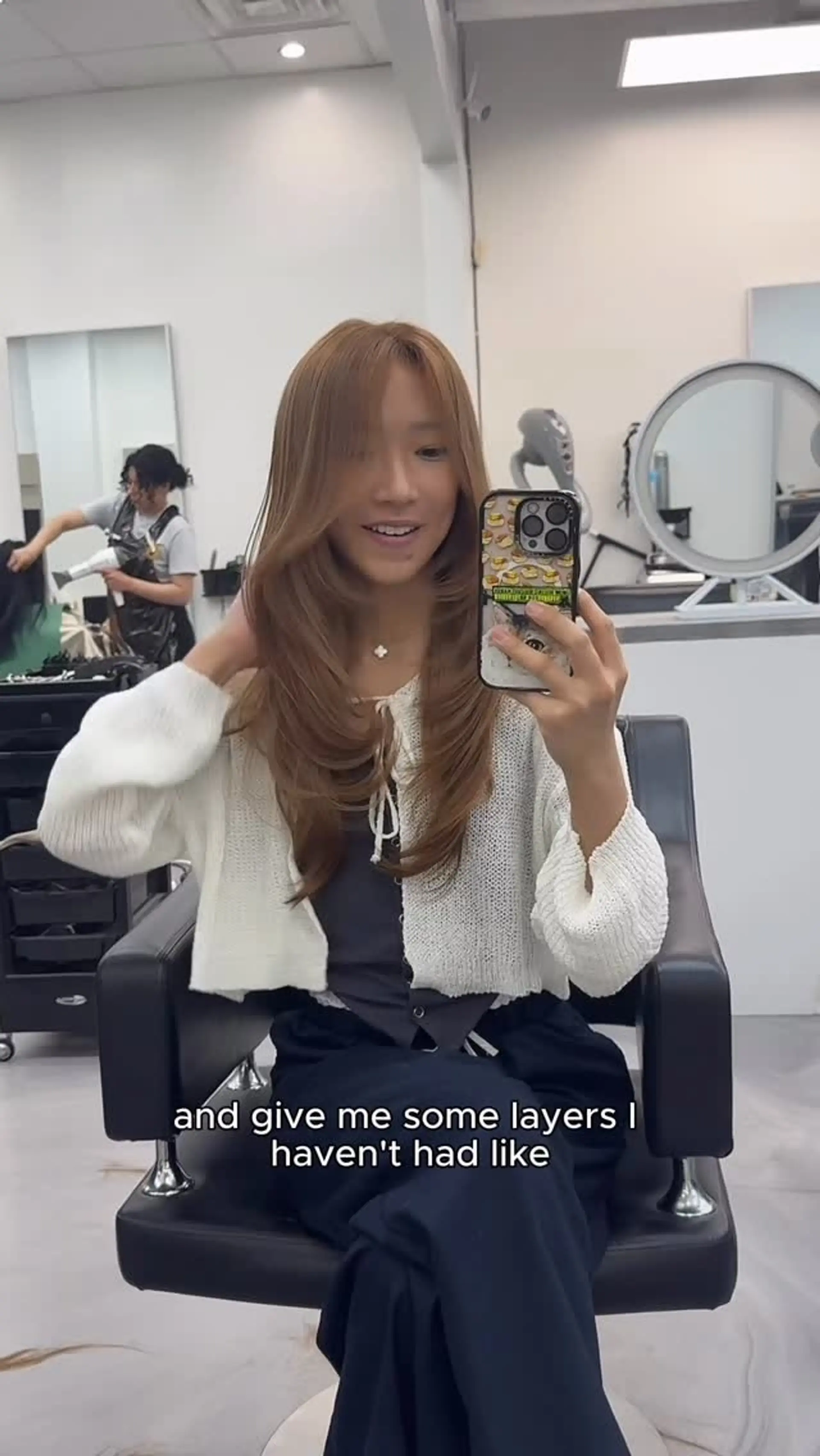Long caramel brown hair cut into soft, cascading layers with face-framing curtain bangs and inward curved ends. 1