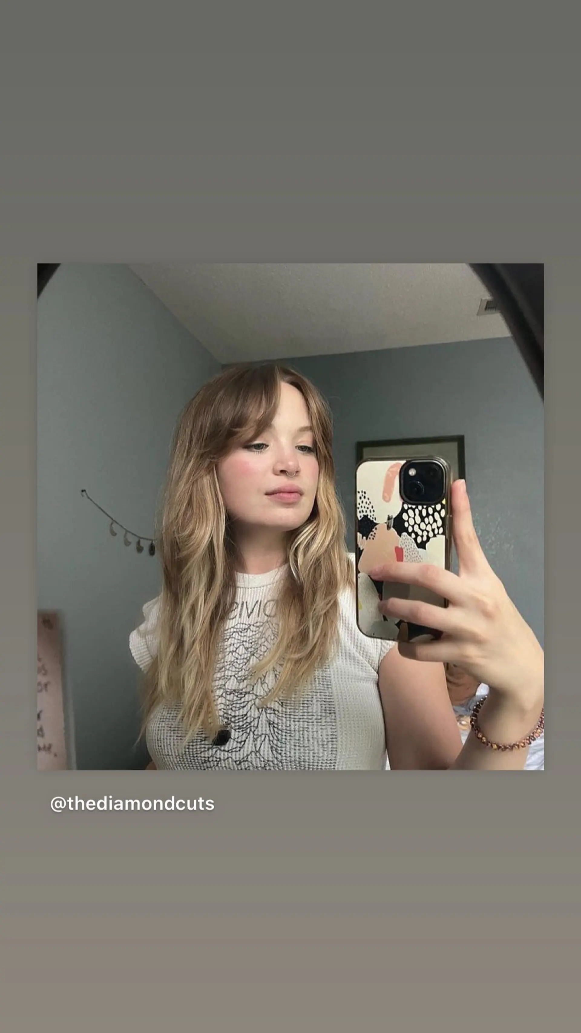 Long, layered wavy hair with wispy bangs. 1