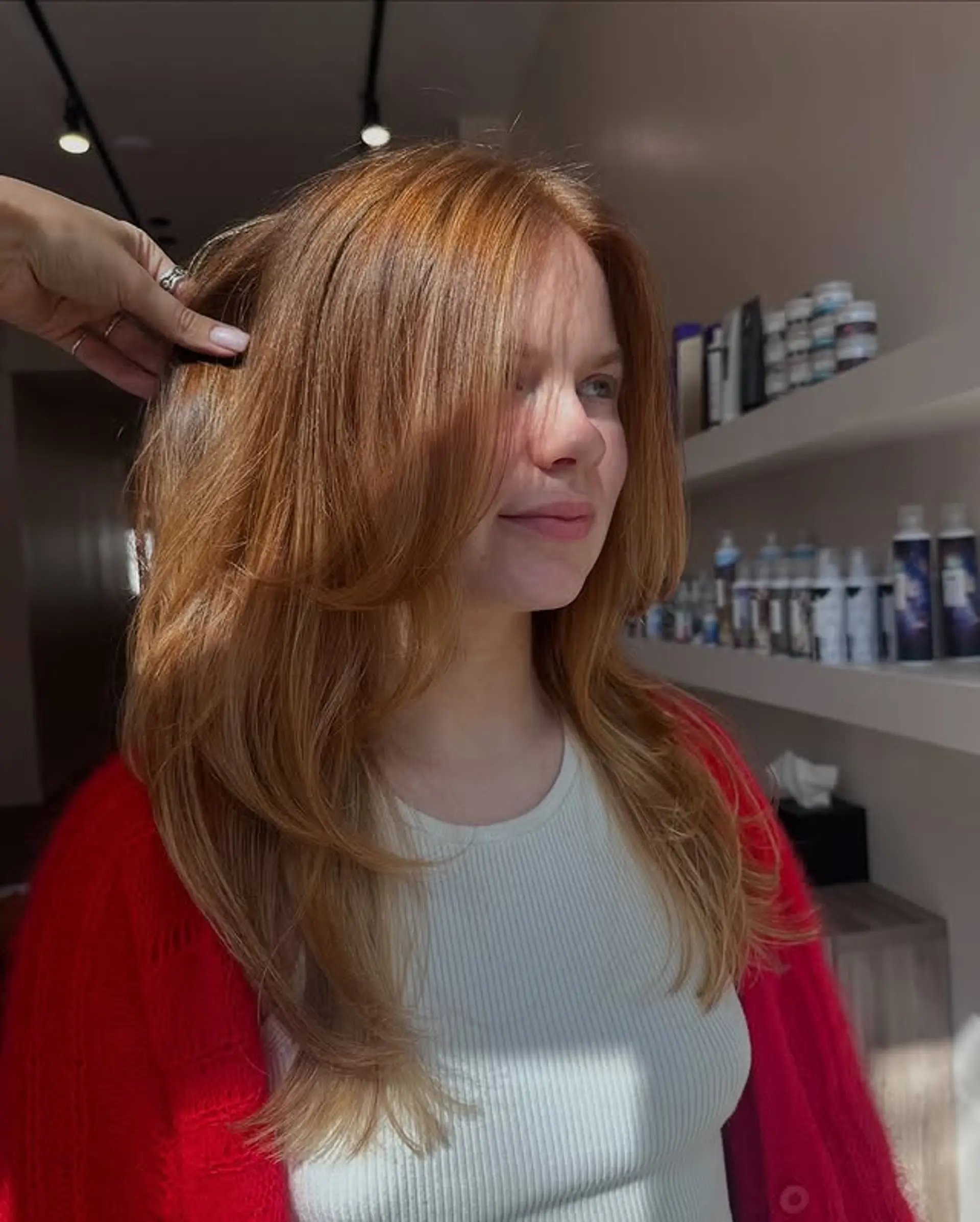 A layered haircut with face-framing layers and curtain bangs. 1