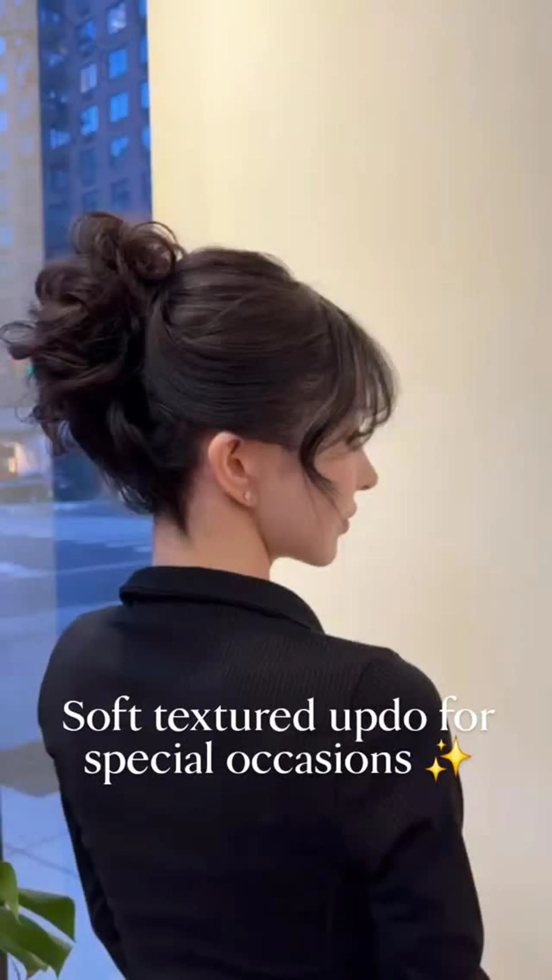A soft, textured updo bun with gentle face-framing tendrils and wispy fringe. 1