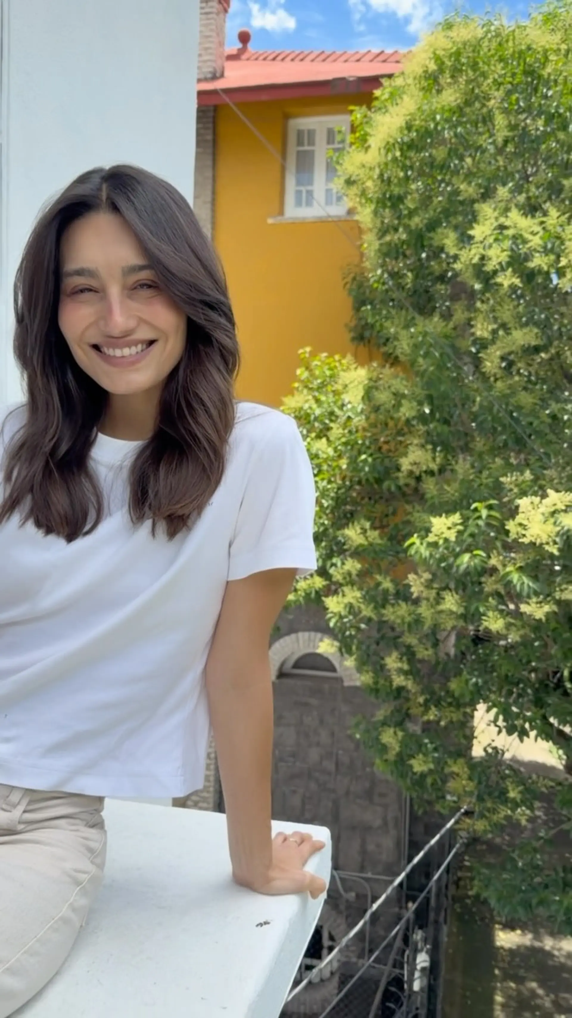 Medium-length dark brunette haircut featuring soft, subtle layers and face-framing movement. 1