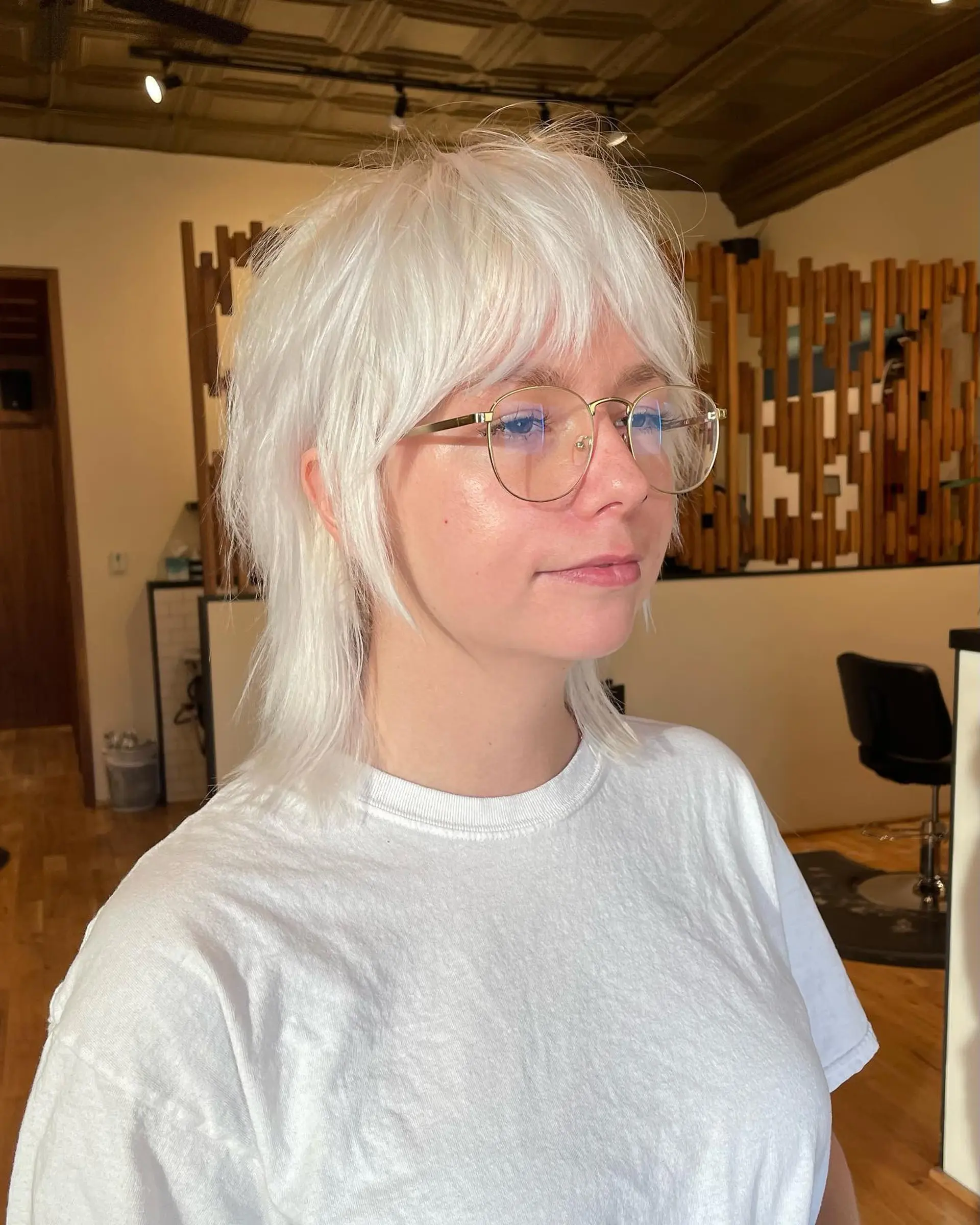 A modern, shaggy mullet with textured layers and face-framing bangs. 1