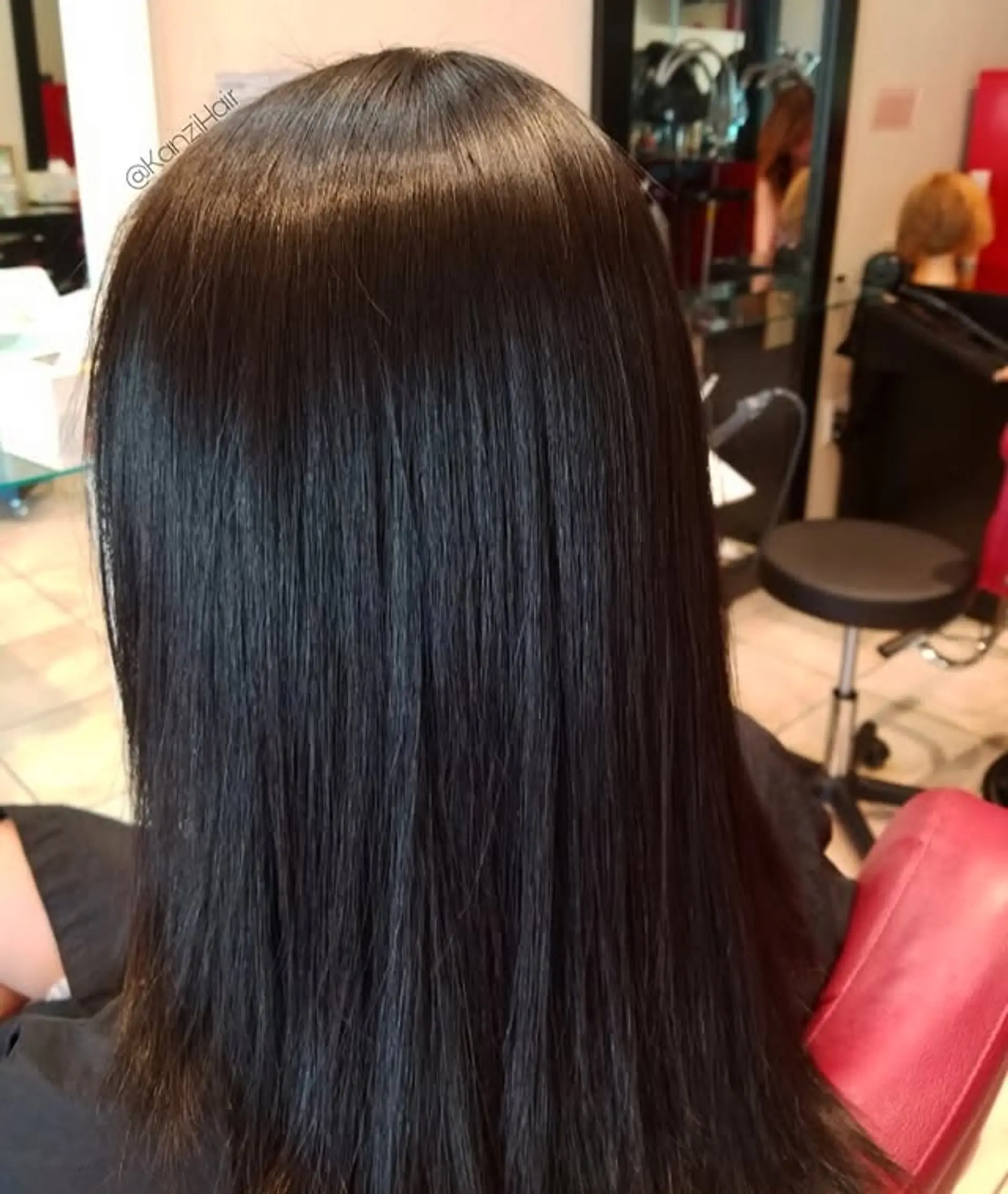This hairstyle features perfectly straight, sleek hair extending to a long length. The cut is clean and uniform, showcasing the hair's natural luster and smooth texture. 1