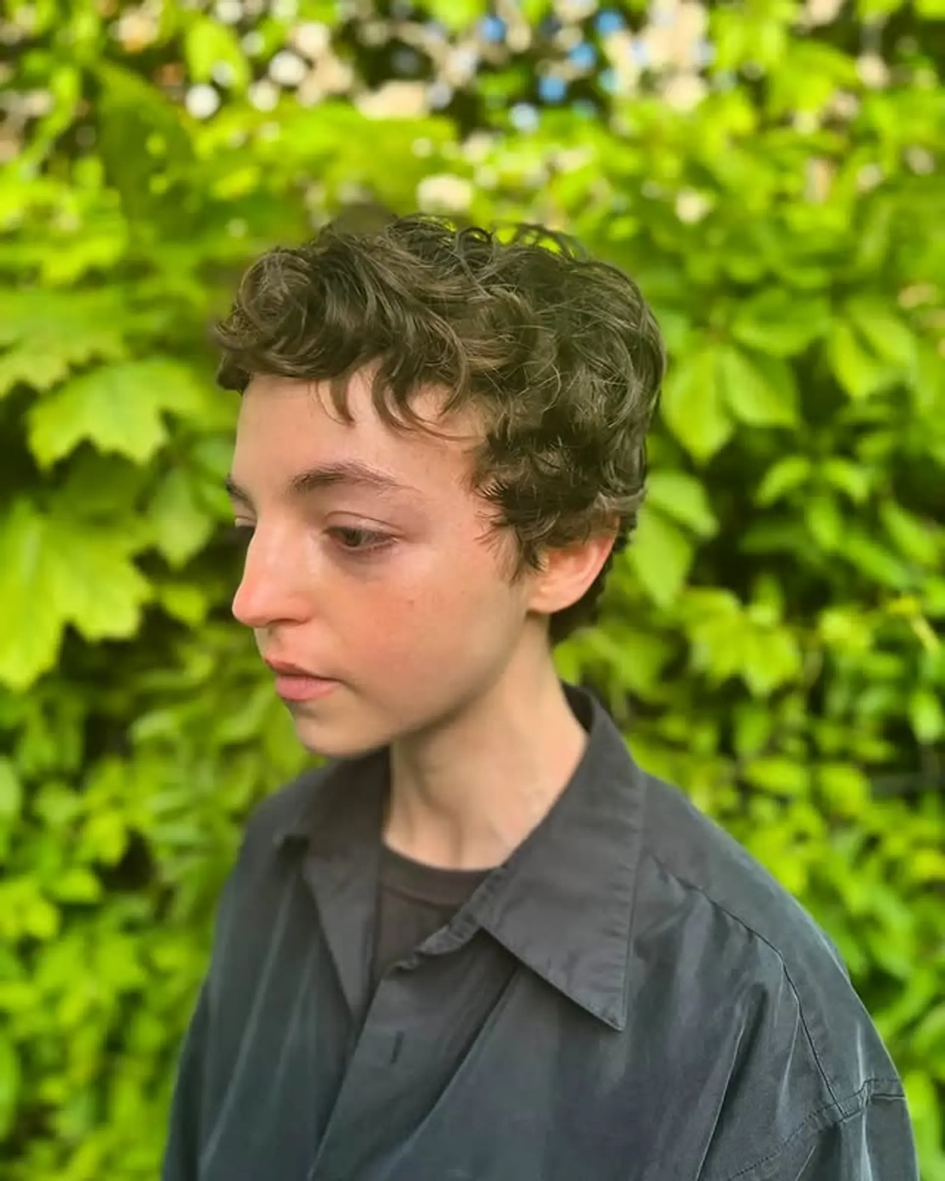 A short, textured pixie cut designed to enhance natural curls. 1